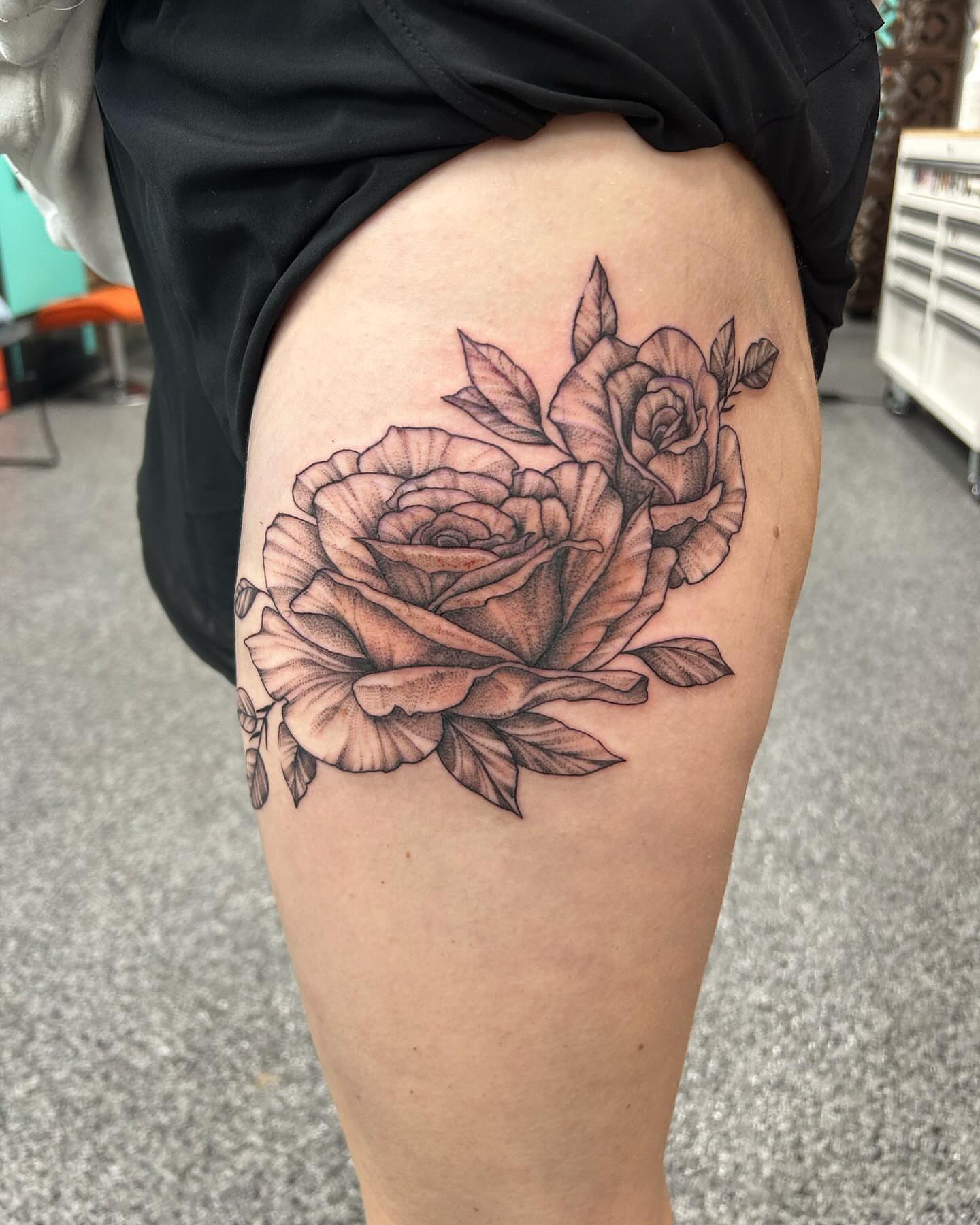 Roses black and grey tattoo on the thigh by Jayda Shell