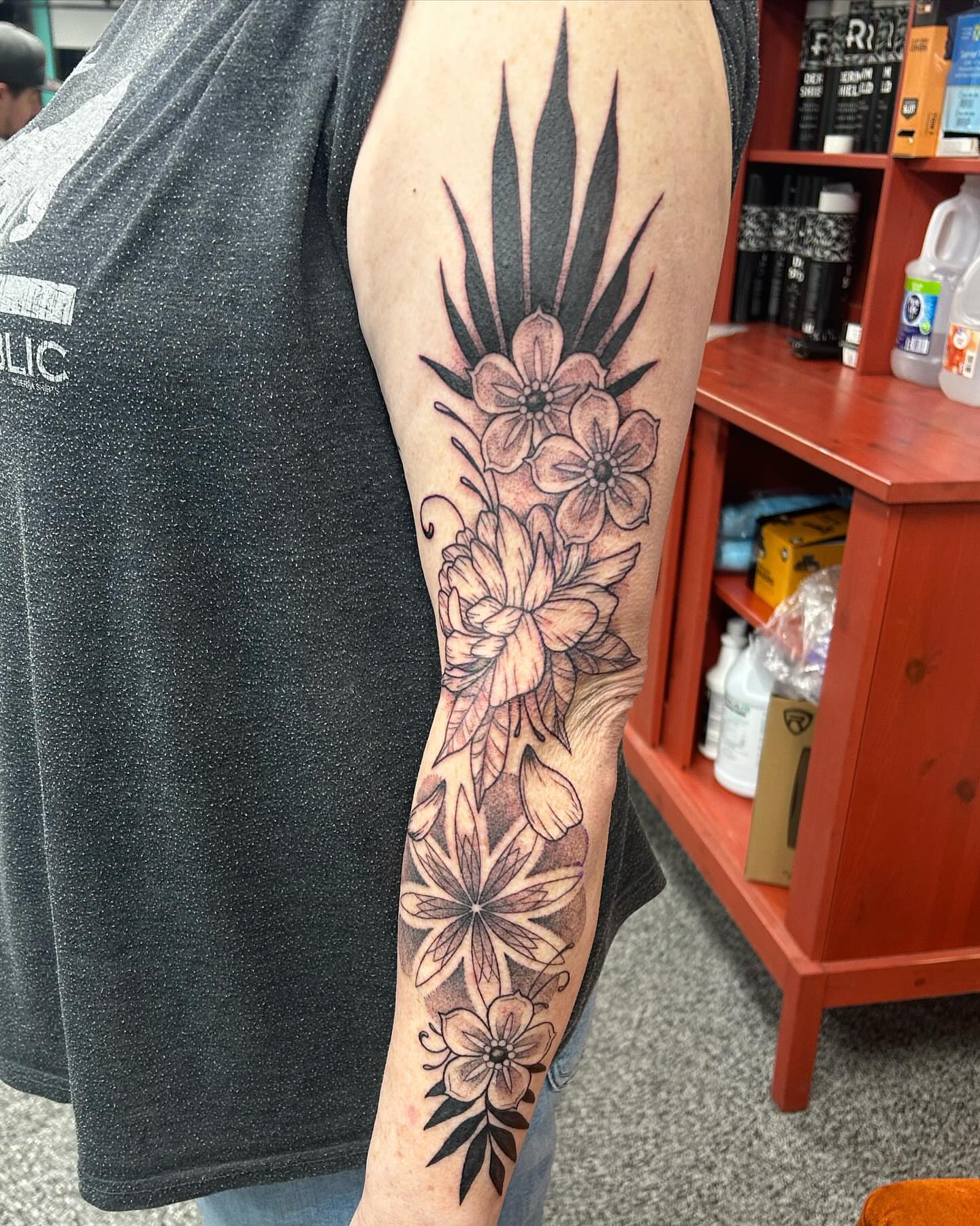 Floral arrangement black and grey tattoo on the forearm by Jayda Shell