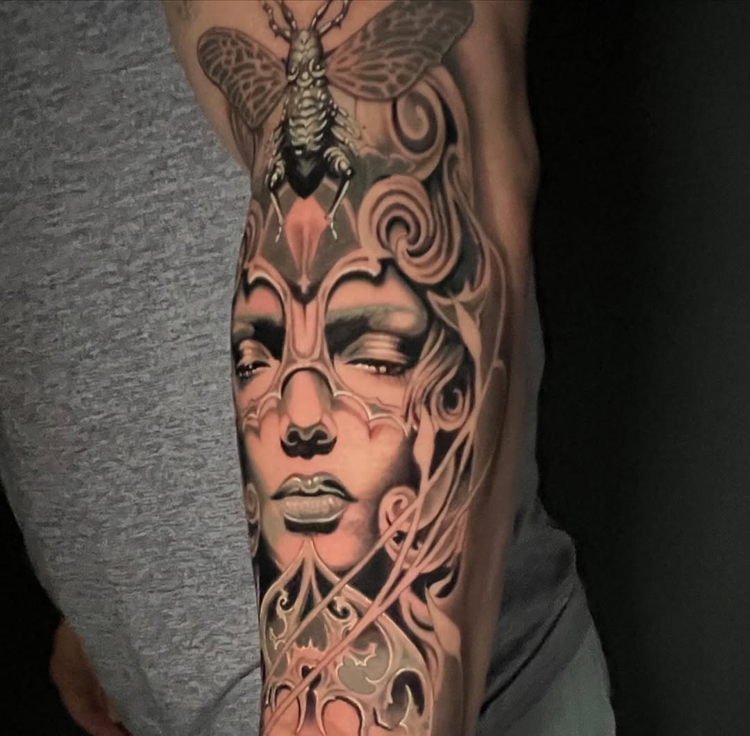 Ornate female face with insect realism tattoo on the forearm by Kayden DiGiovanni, Addison, Texas