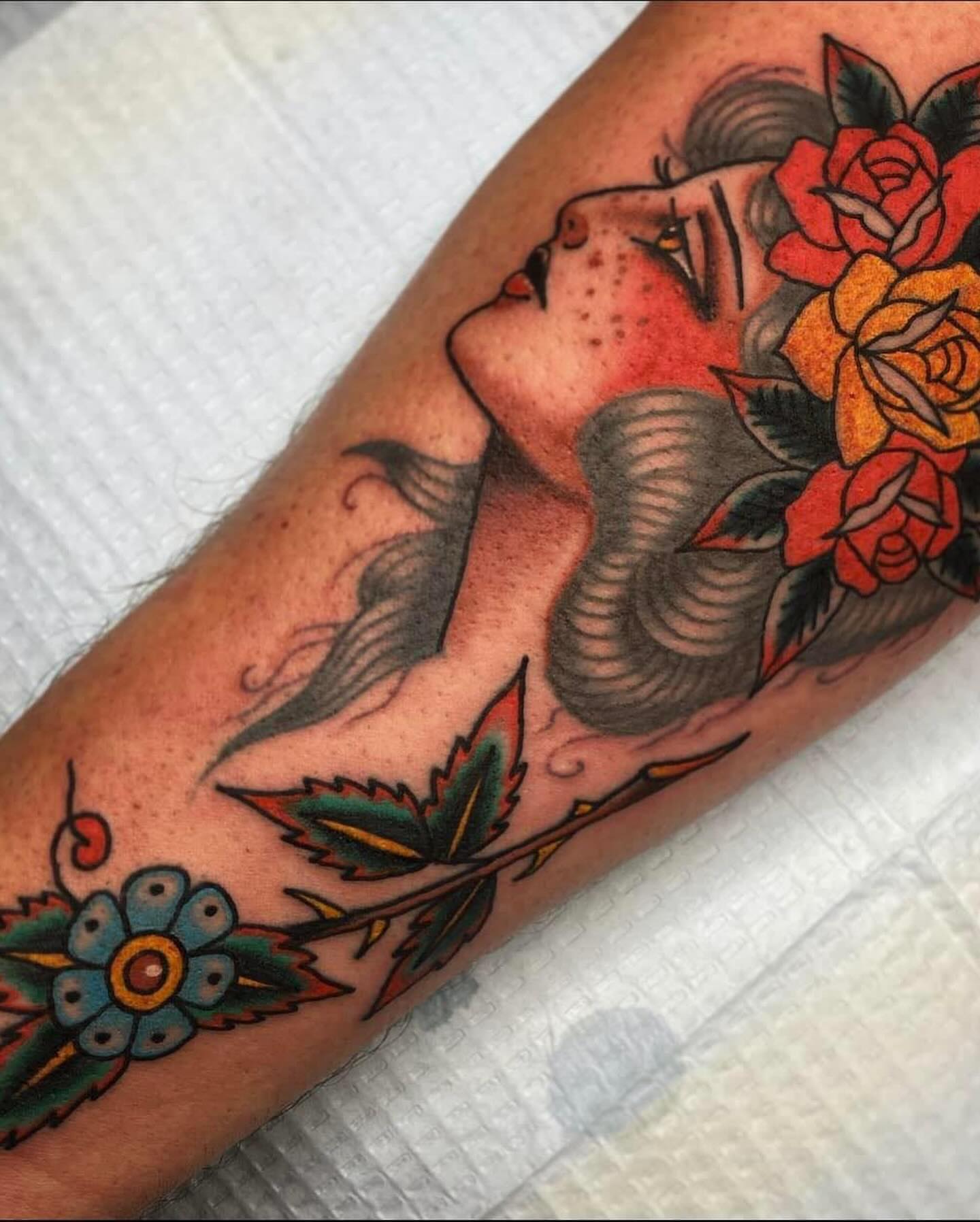 Mermaid and roses American traditional tattoo on the forearm by Drew McElveney, Austin, Texas
