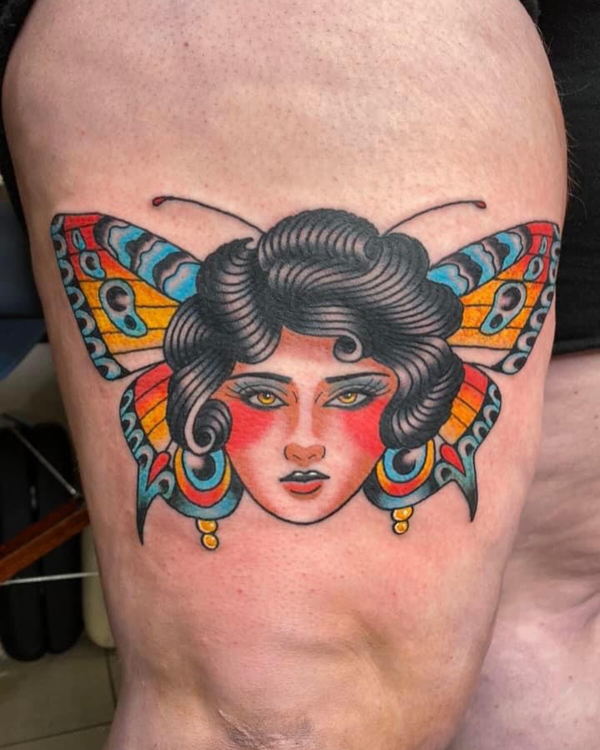 Woman with butterfly wings American traditional tattoo on the thigh by Drew McElveney, Austin, Texas