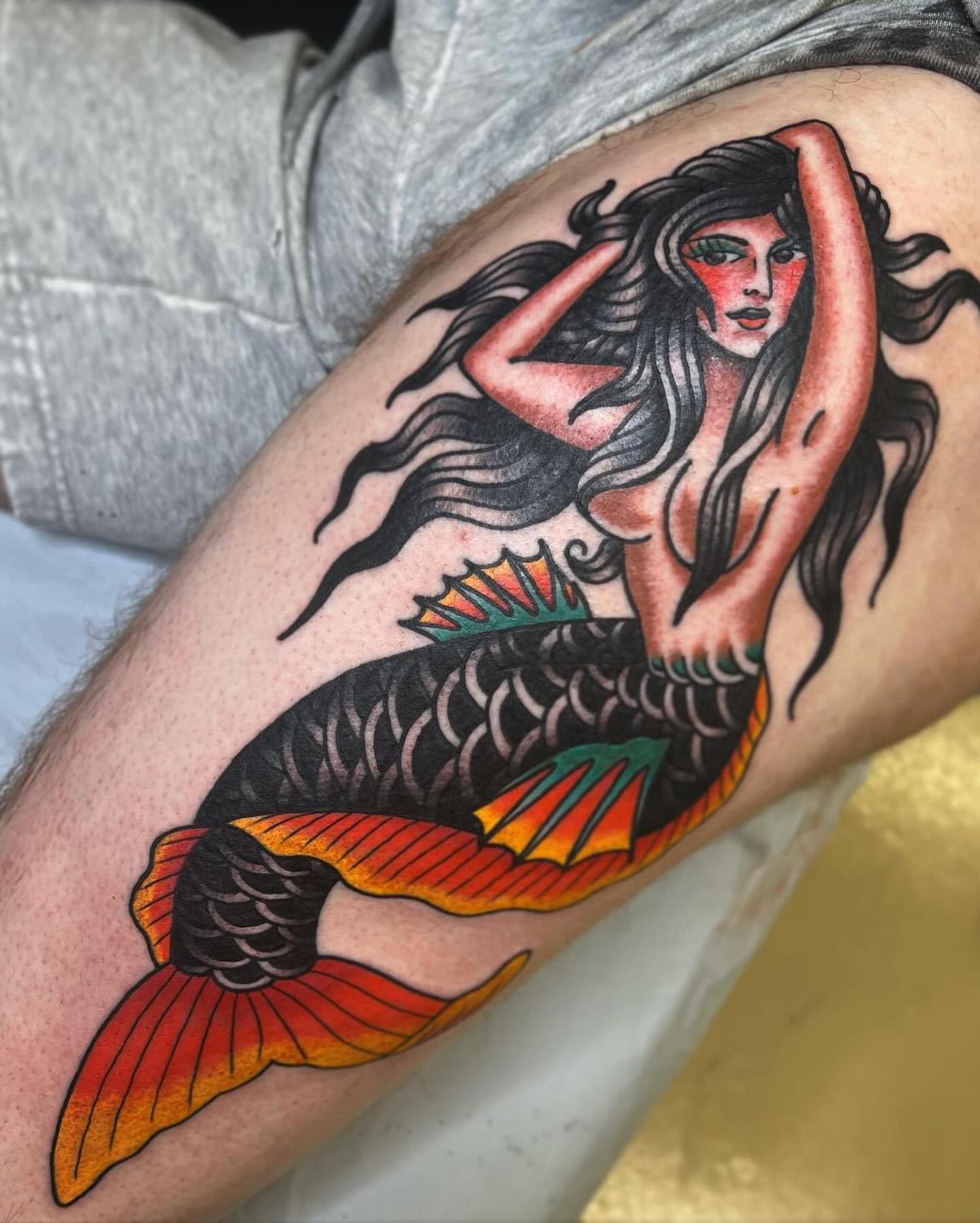 Mermaid American traditional tattoo on the thigh by Drew McElveney, Austin, Texas