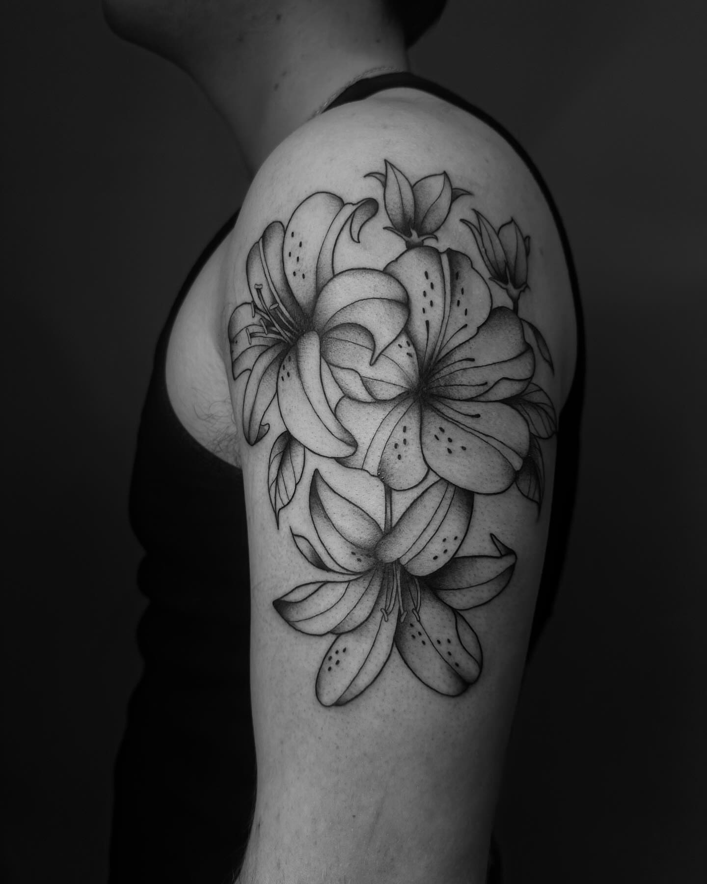 Lilies black and grey tattoo on the upper arm by ꕥ LANA MOON TATU ꕥ