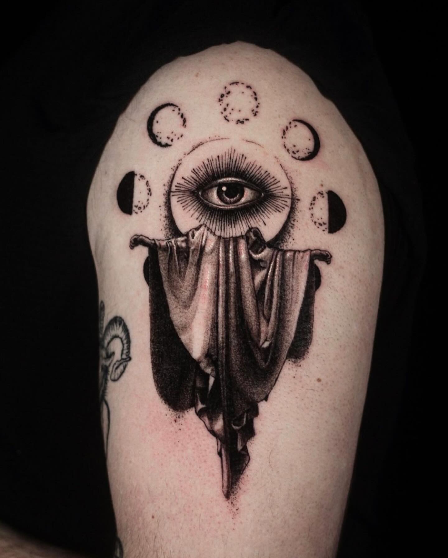 Eye with crescent moons realism tattoo on the shoulder by H.black