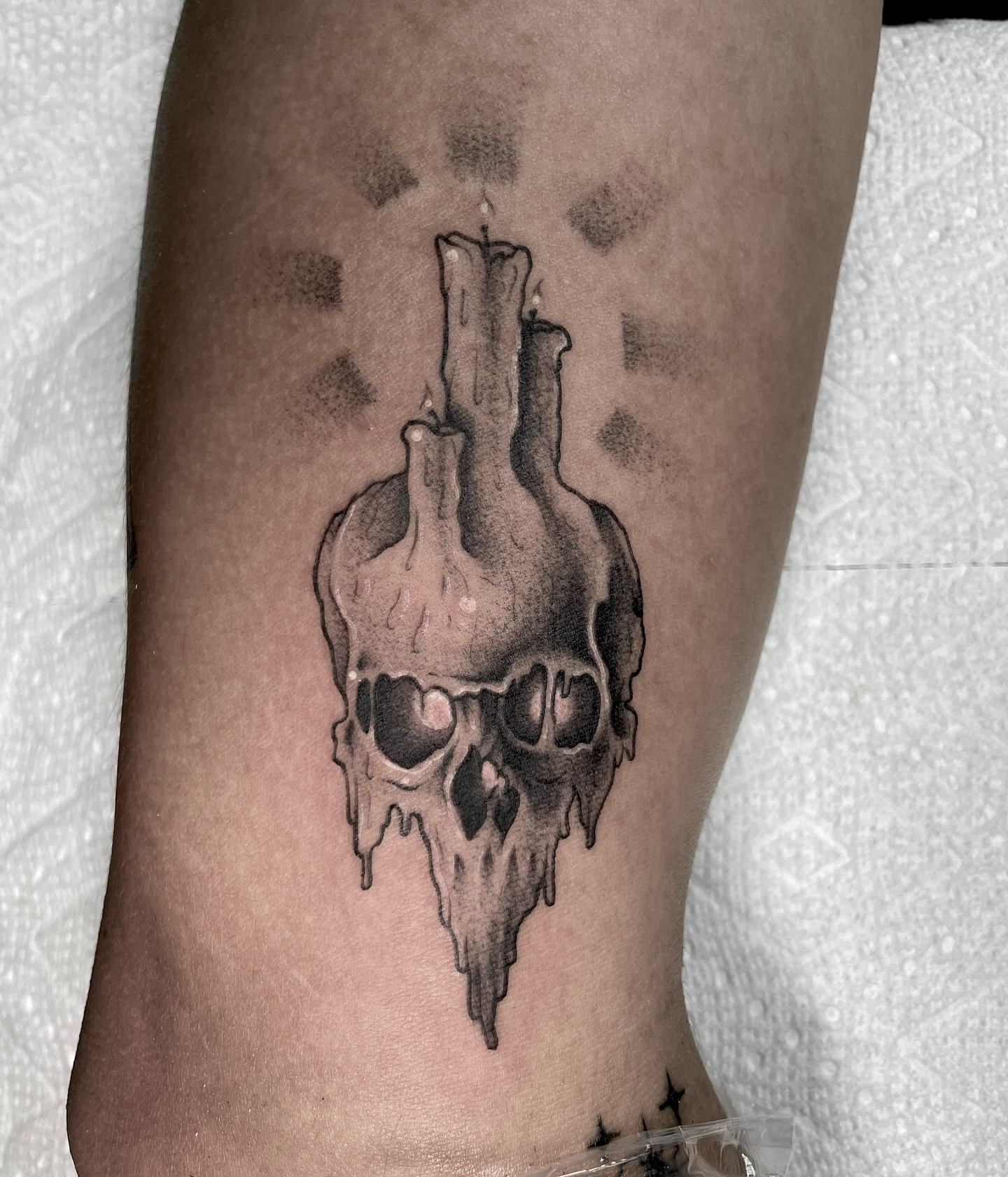 Melting skull dark realism tattoo on the forearm by Bryan