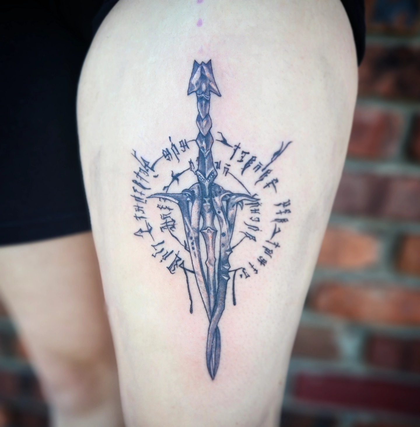Sword black and grey tattoo on the thigh by Jennalea
