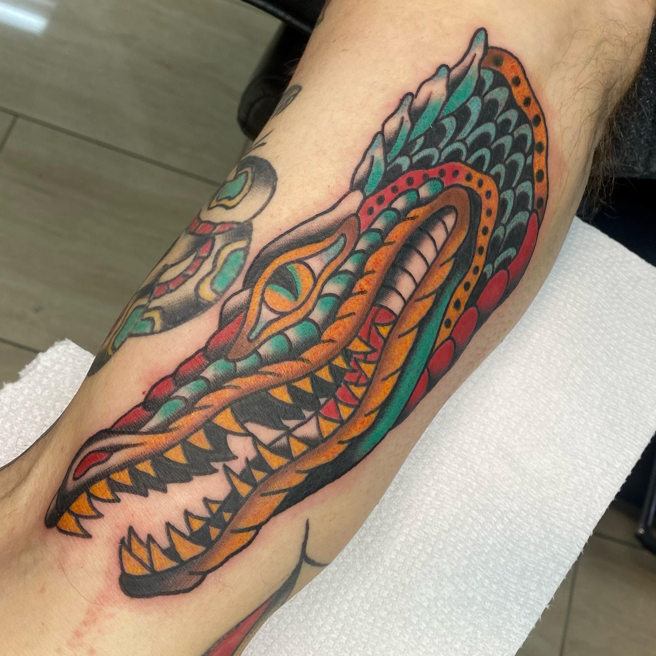 Dragon American traditional tattoo on the forearm by Shana