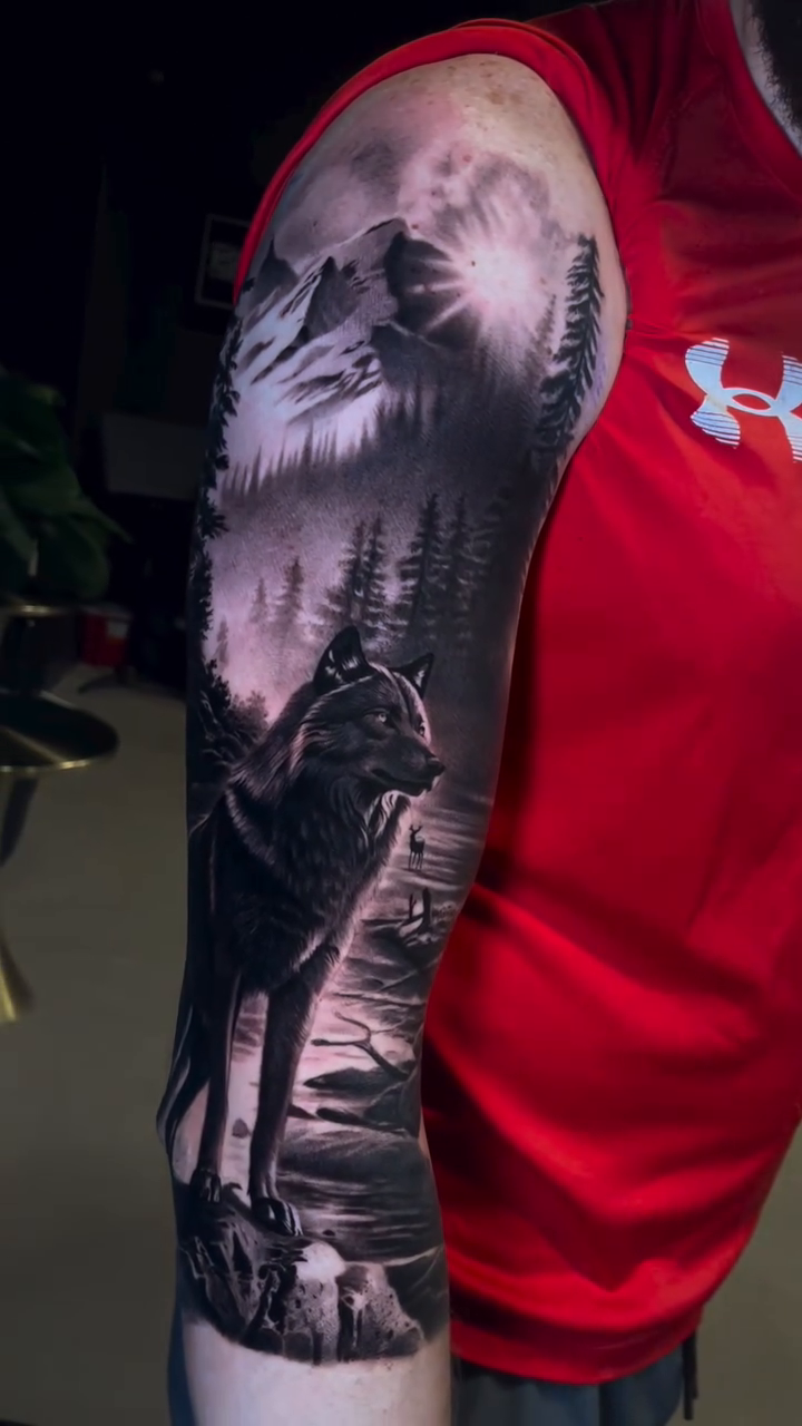 Wolf in a forest landscape realism tattoo by Martin Reyes Jr