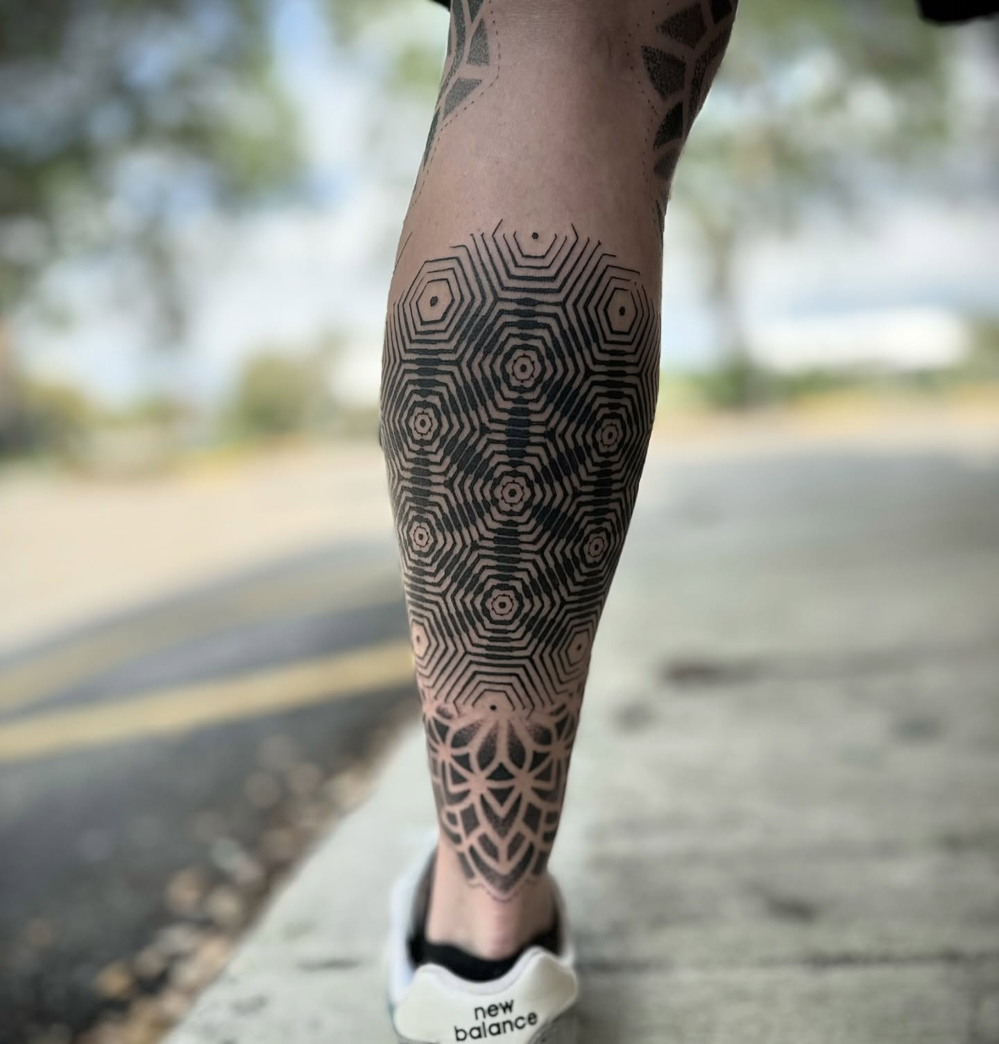 Geometric pattern geometric tattoo on the calf by Paul Schnell