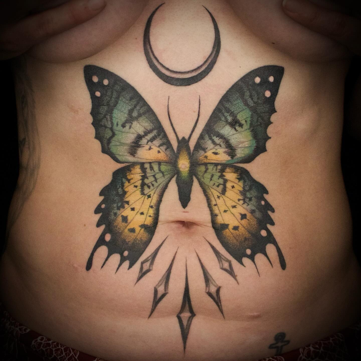 Butterfly geometric tattoo on the chest by Galen