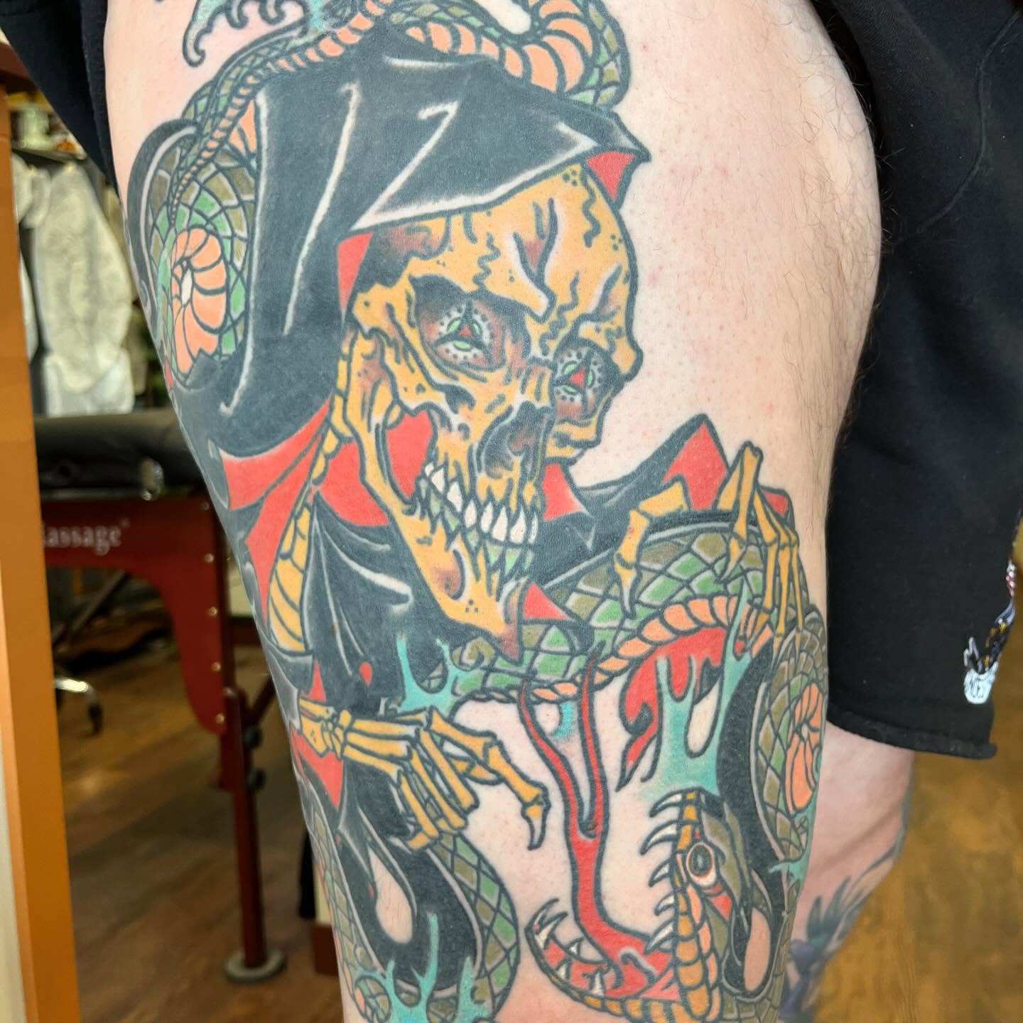 Skull and dragon American traditional tattoo on the thigh by Blake Brand