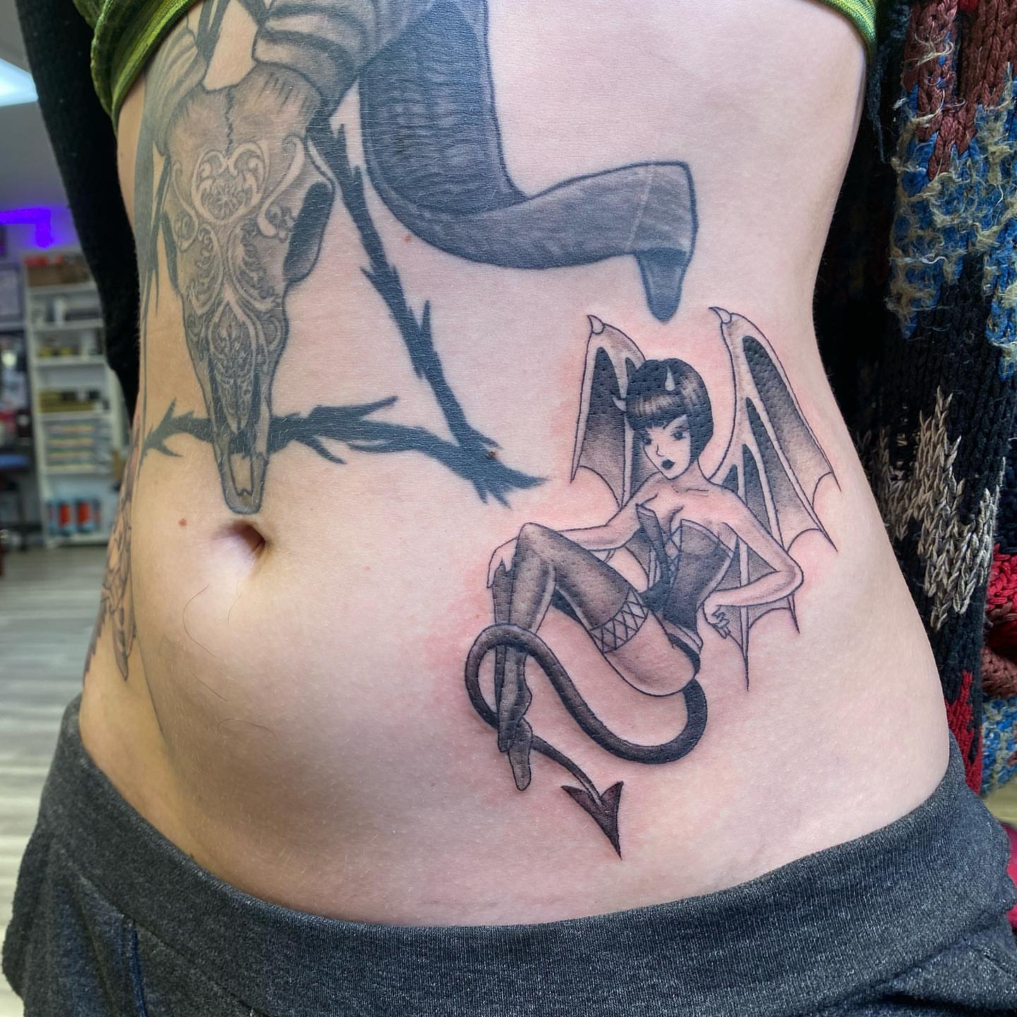 Demon woman black and grey tattoo on the torso by Tattertot