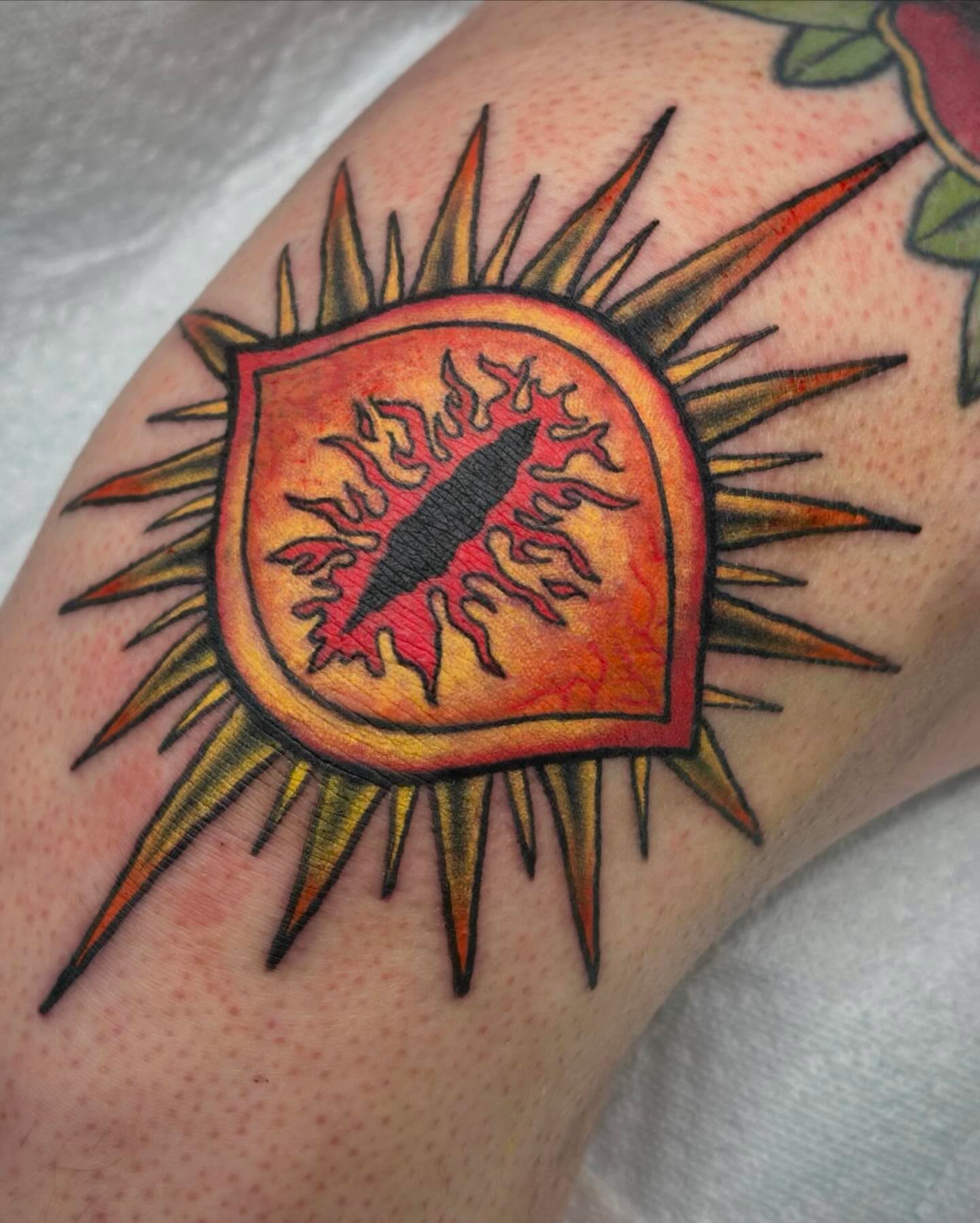 Flame and shield American traditional tattoo on the forearm by hannah vertal