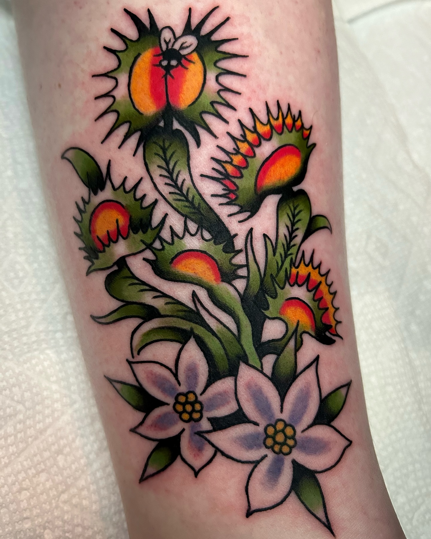 Floral arrangement American traditional tattoo on the forearm by Mitch Hoggard