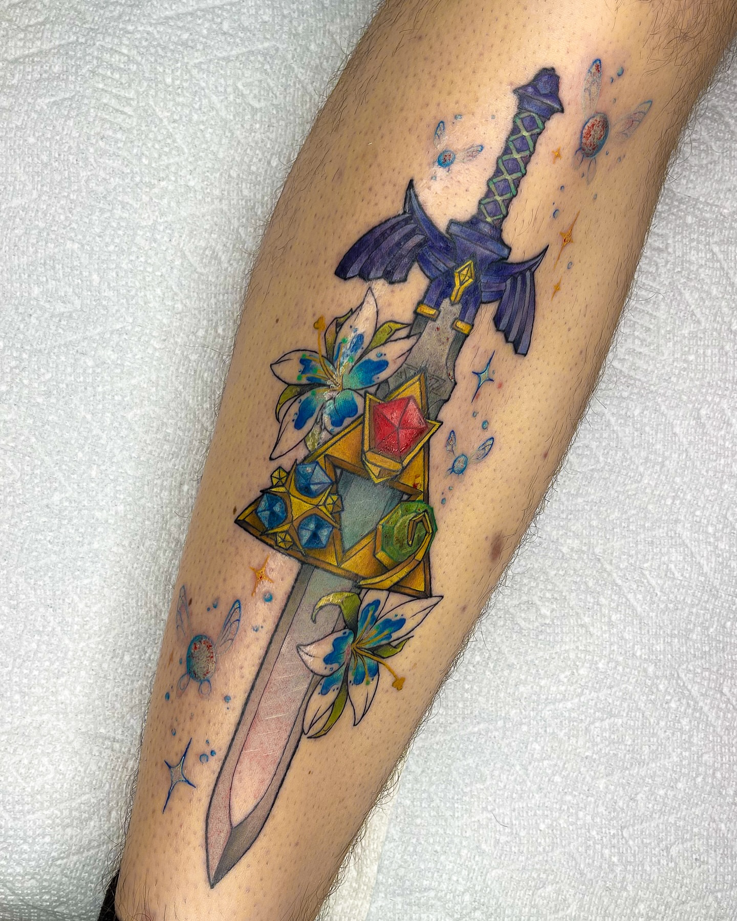 Sword and triforce geometric tattoo on the forearm by Lexx Christine