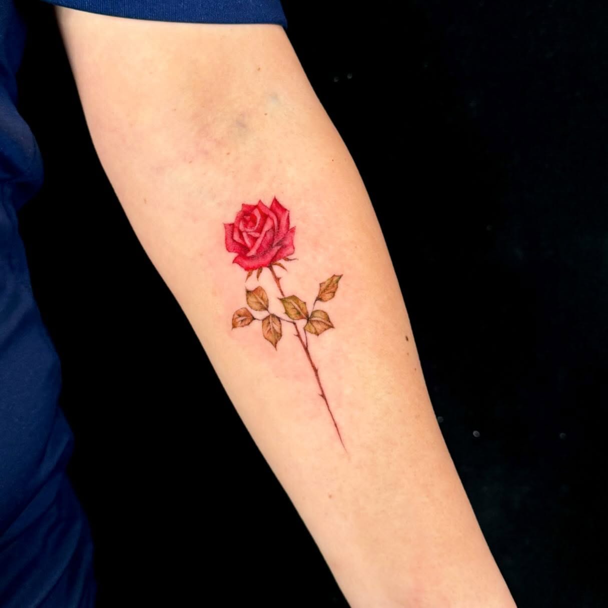 Rose realism tattoo on the forearm by Navei