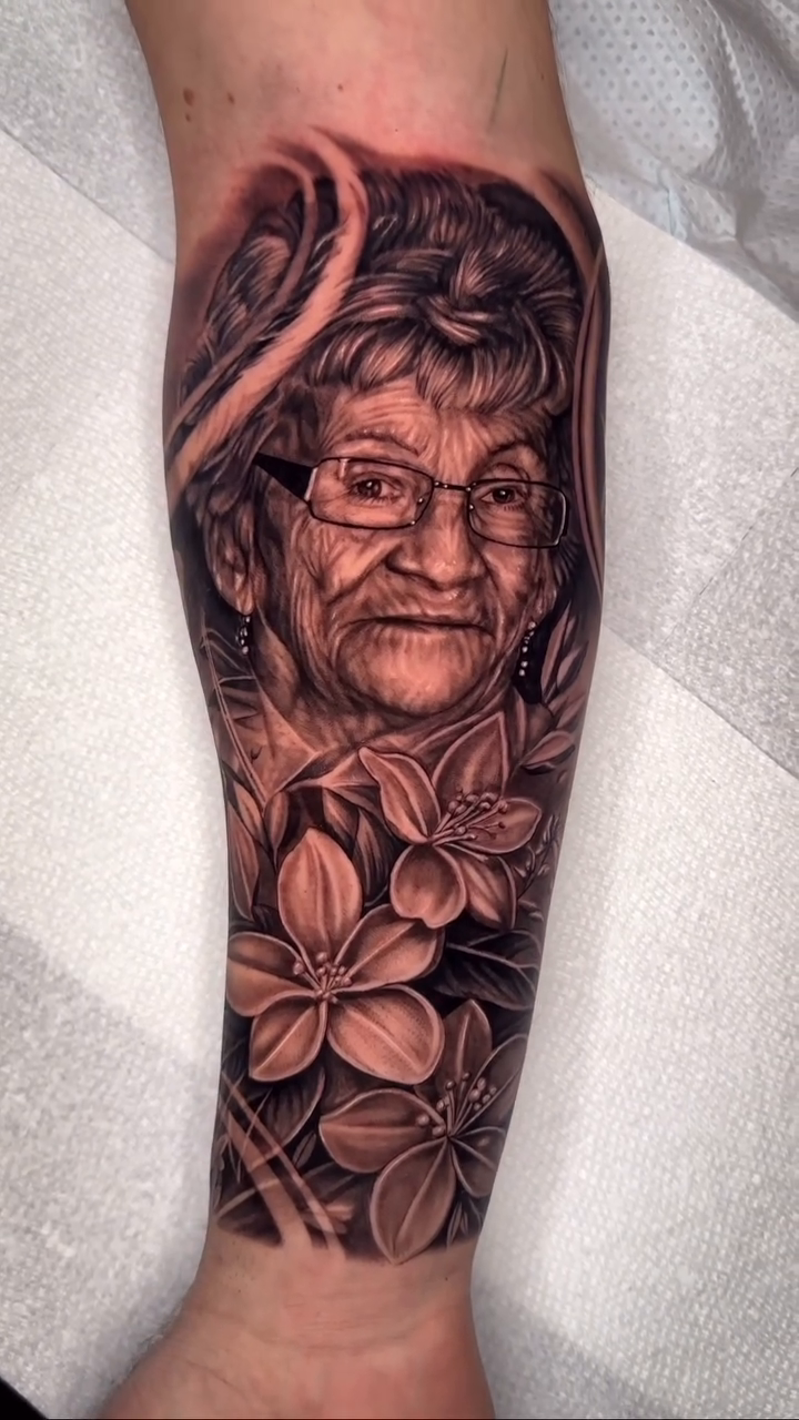 Portrait of a woman with flowers realism tattoo by Steven tattoo