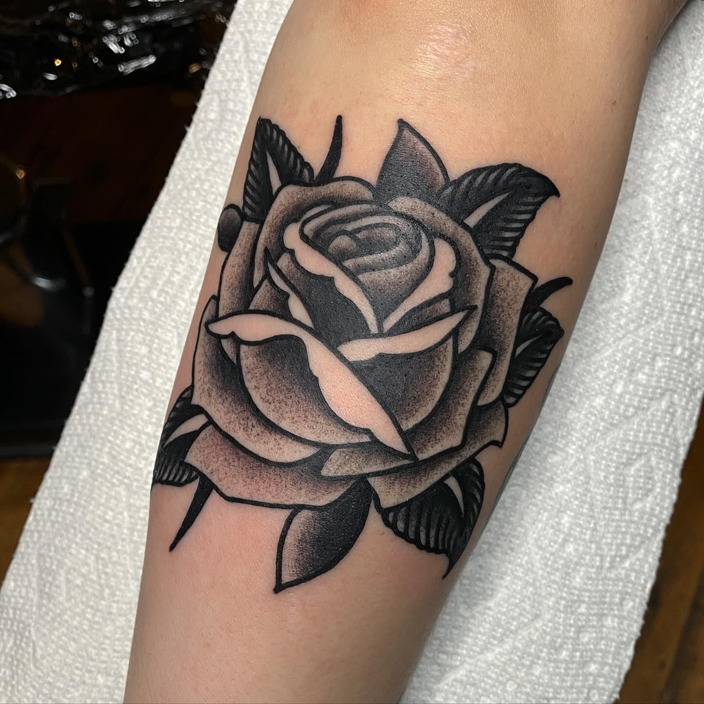 Rose black and grey tattoo on the forearm by kenneth nash