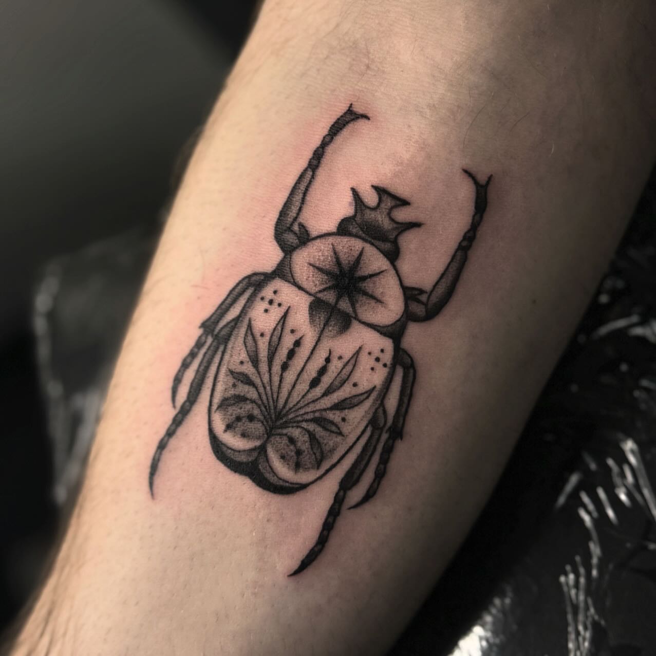 Scarab beetle black and grey tattoo on the forearm by โโฎโ๐ถ๐๐ฝ๐๐๐ู เฃชโญ las vegas tattoo artist
