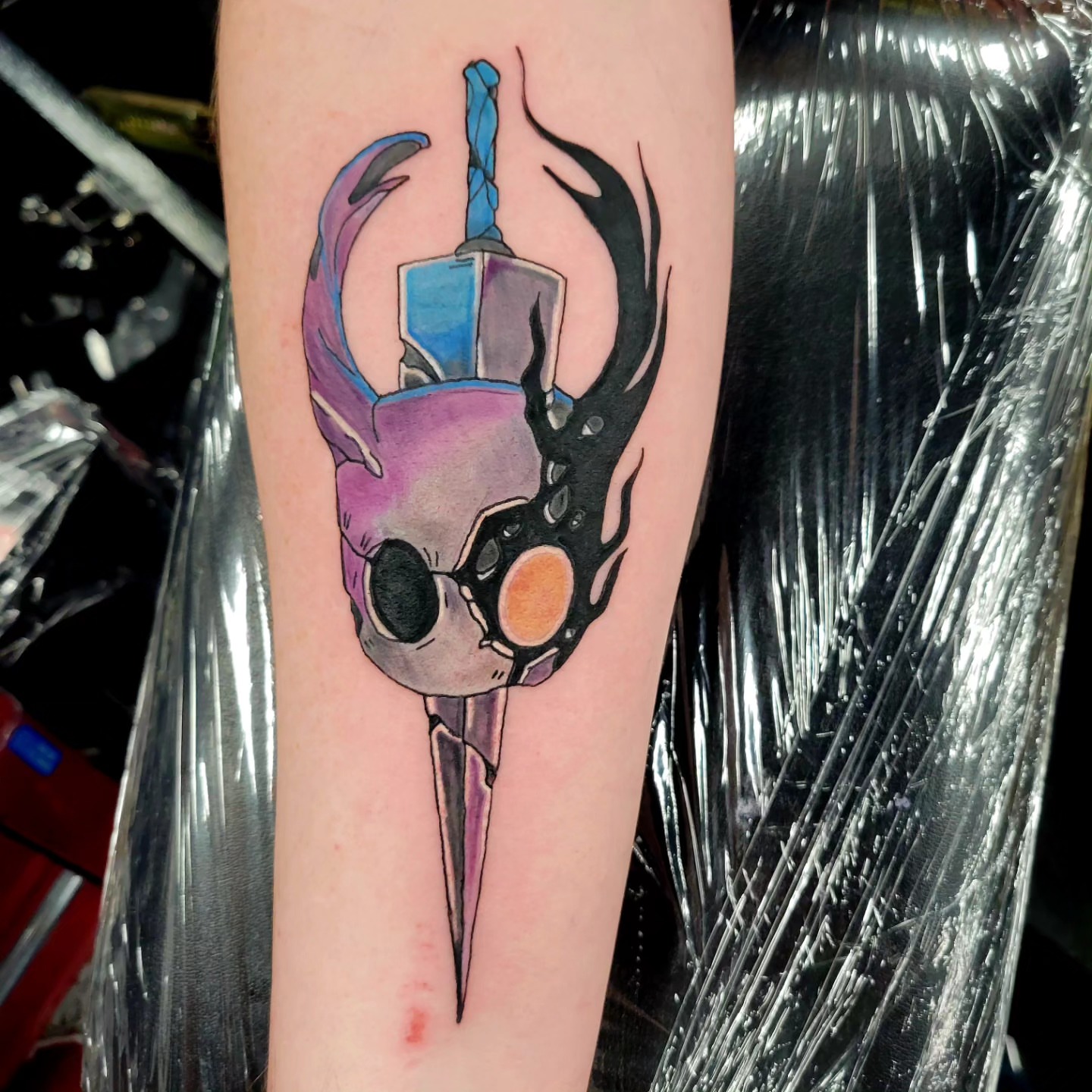 Mask with mechanical elements watercolor tattoo on the forearm by Naez Ink AKA Renae Madison, Macomb, Illinois