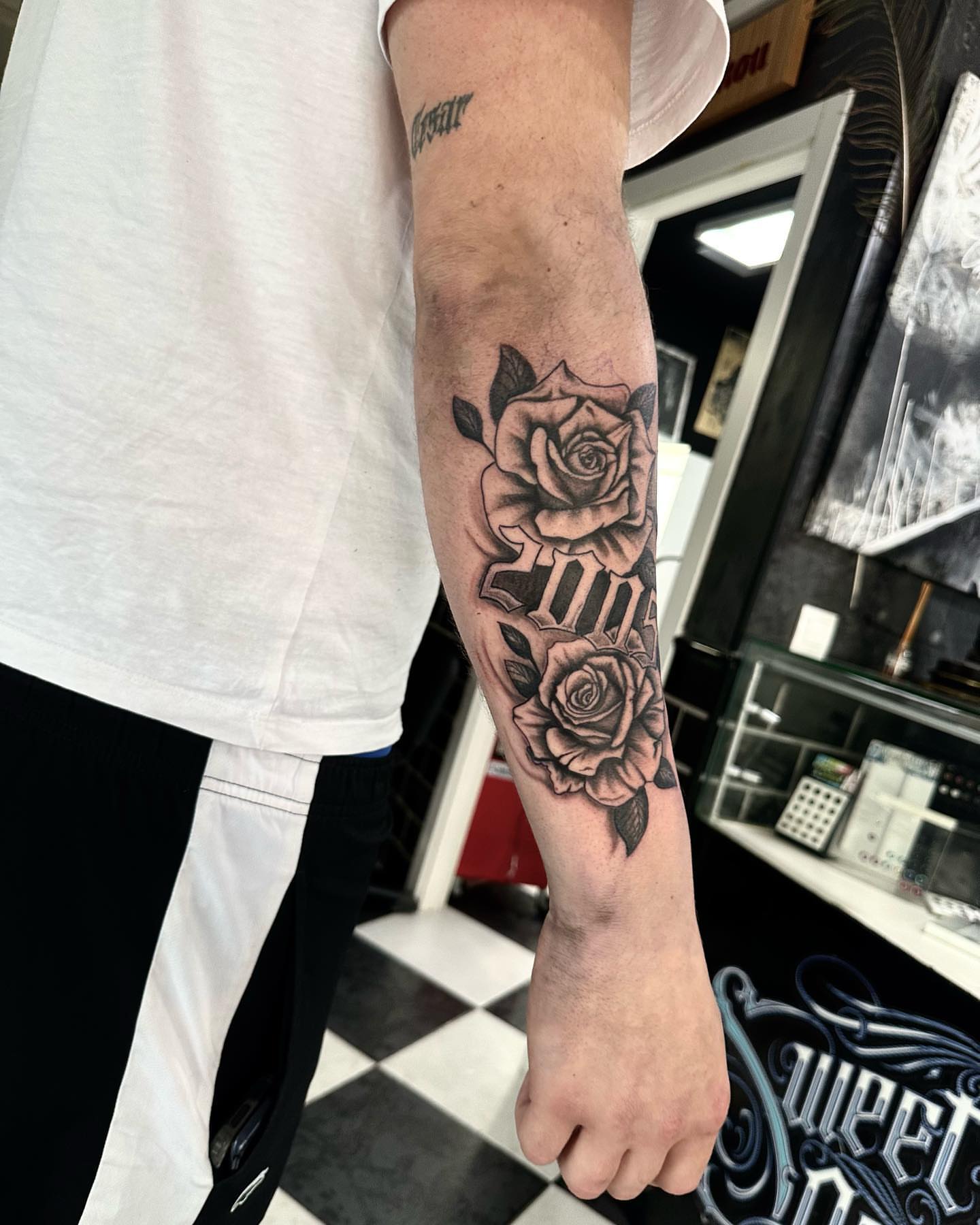 Roses black and grey tattoo on the forearm by Kunaytattoo