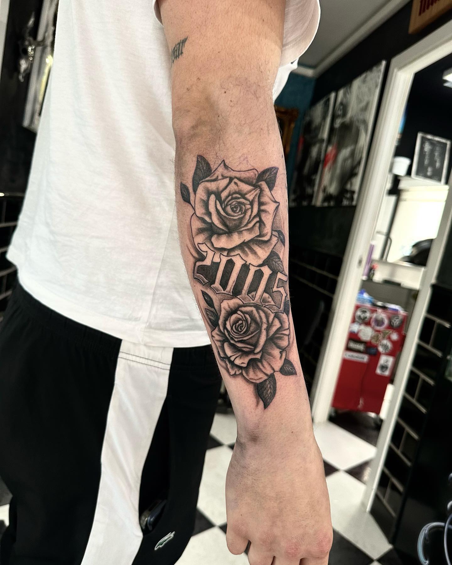 Roses black and grey tattoo on the forearm by Kunaytattoo