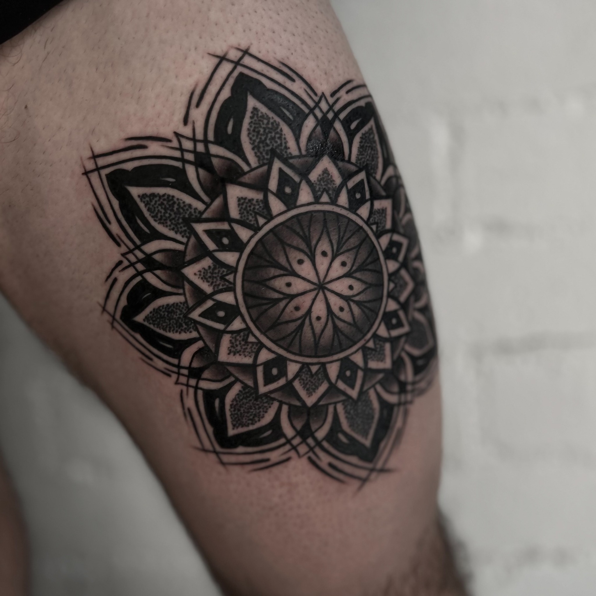 Mandala dotwork tattoo on the thigh by Eric Hare