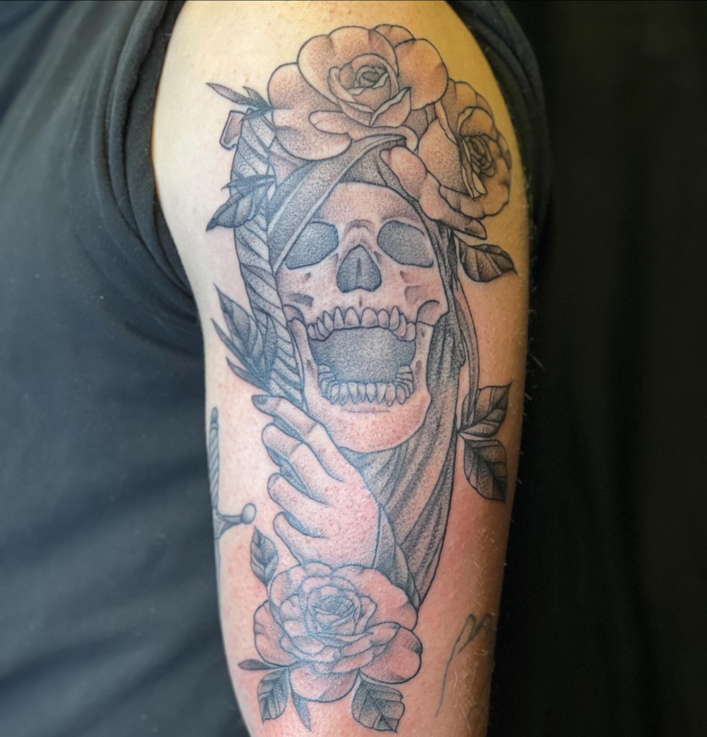 Skull with roses dotwork tattoo on the forearm by Dani McBay