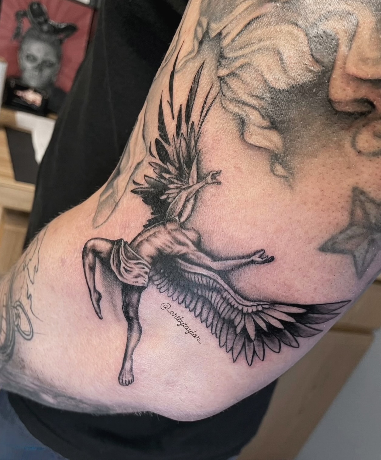 Winged angel black and grey tattoo on the upper arm by Taylor✍🏽️