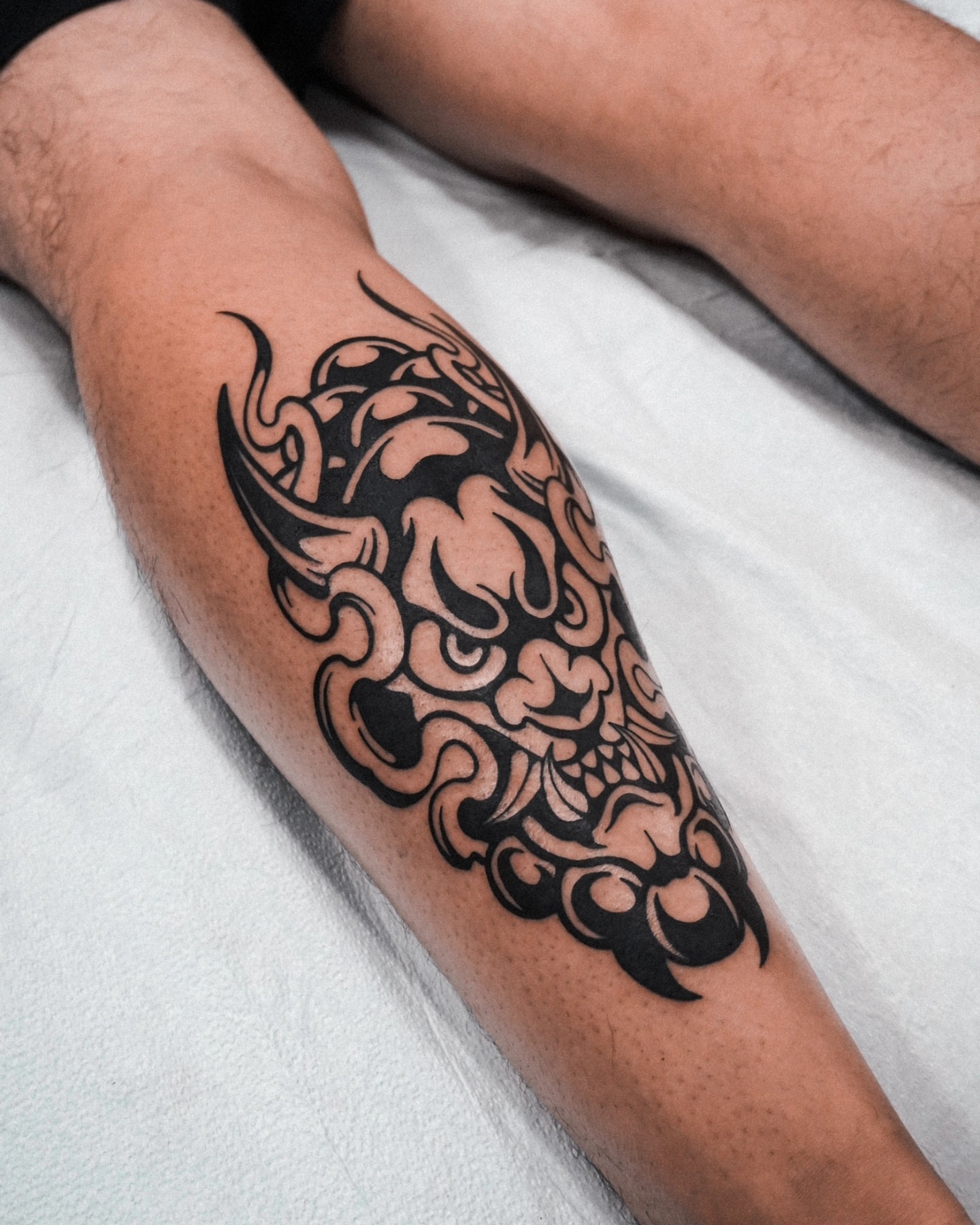 Mask tribal tattoo on the forearm by Jeremy "Jerms" Camposanto