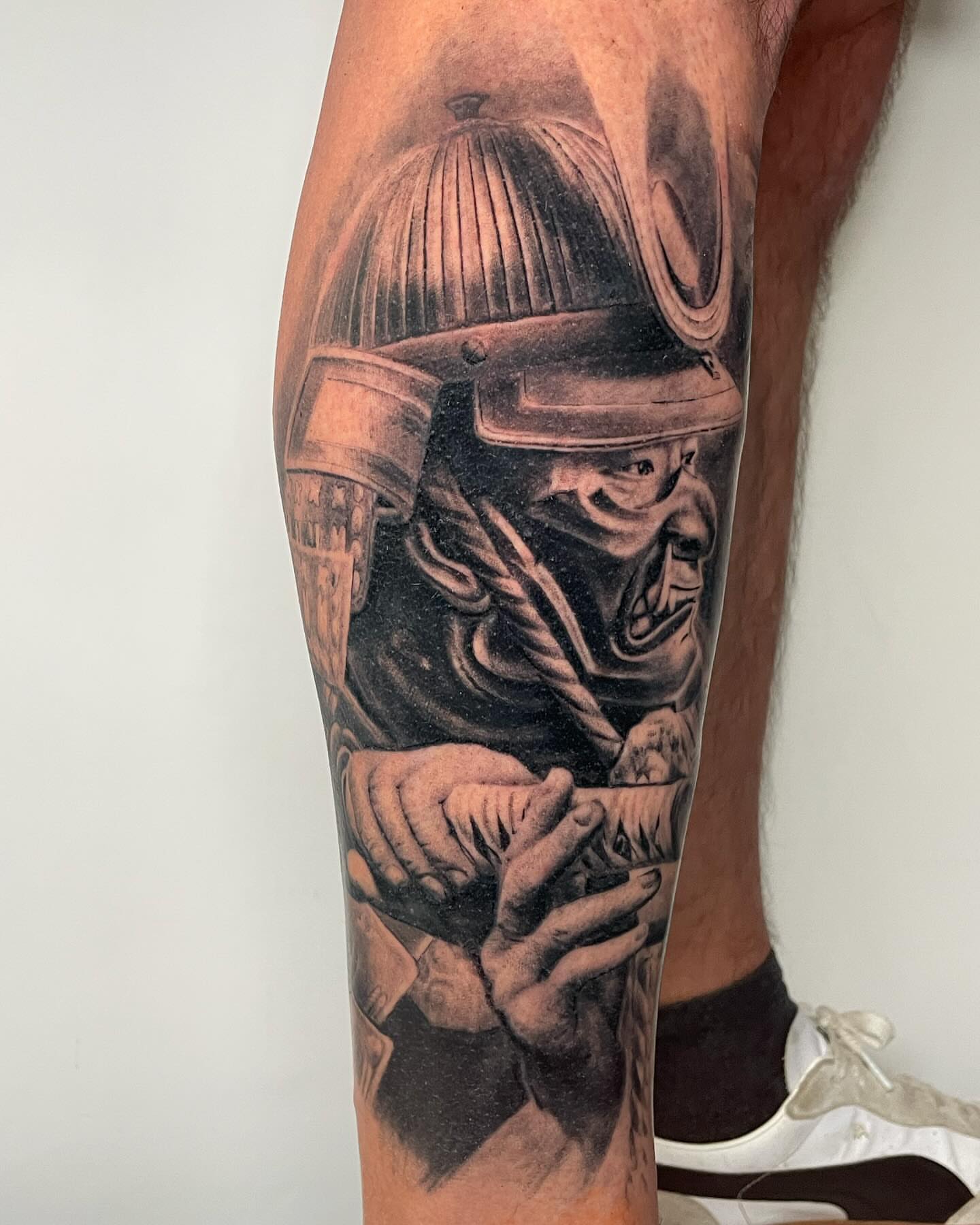 Warrior helmet realism tattoo on the calf by Justin Reid, San Jose, California