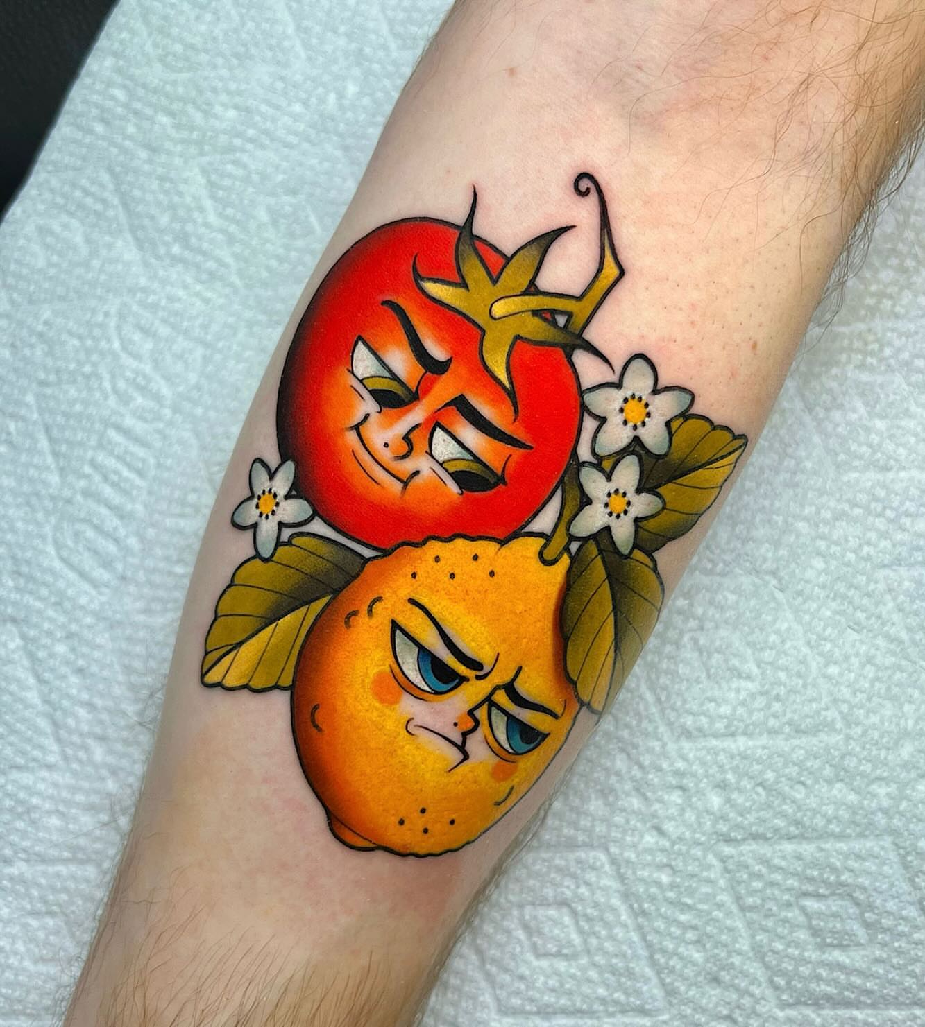 Tomato and orange American traditional tattoo on the forearm by Shelby Ouellette