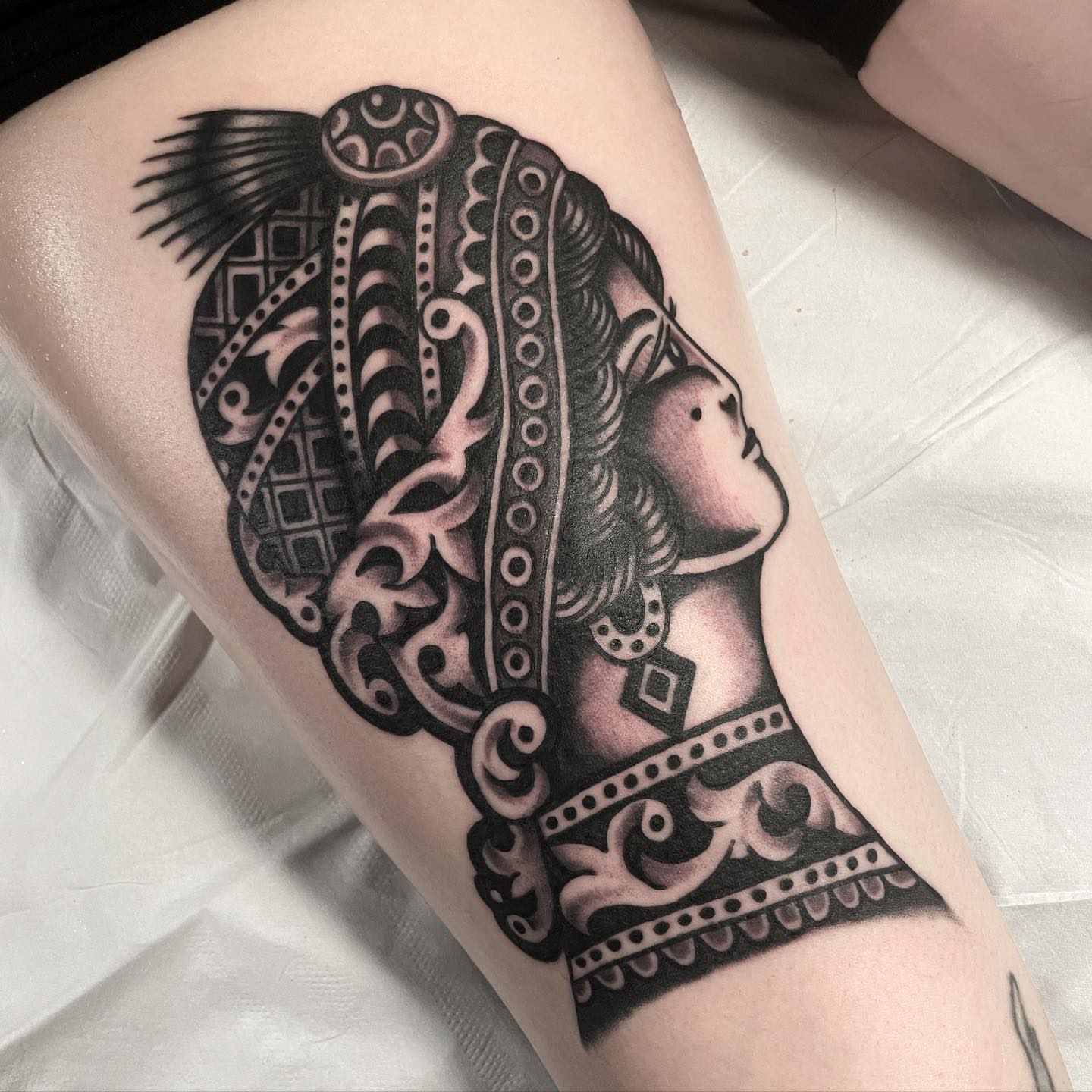 Woman's profile realism tattoo on the forearm by Mike Hudgins