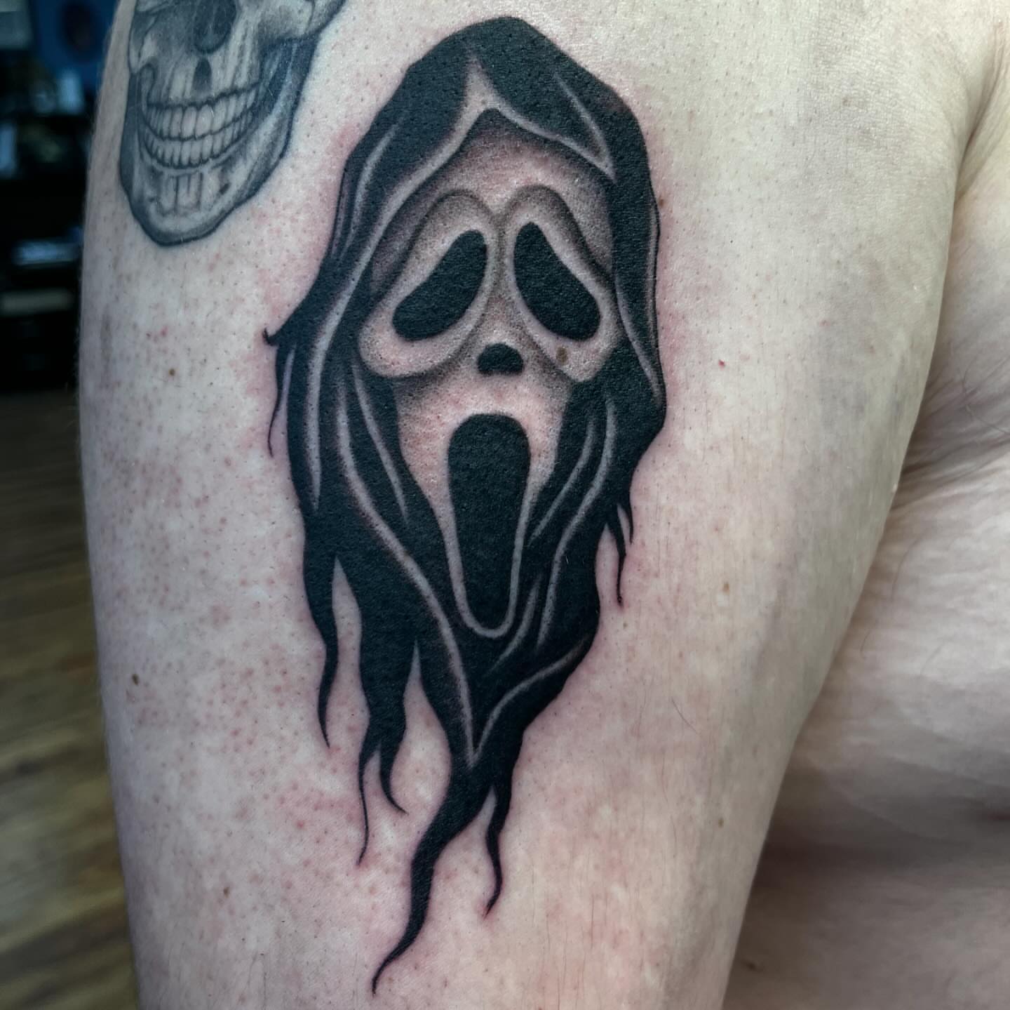 Ghost mask black and grey tattoo on the forearm by Ana Valadez π¦, Ventura, California