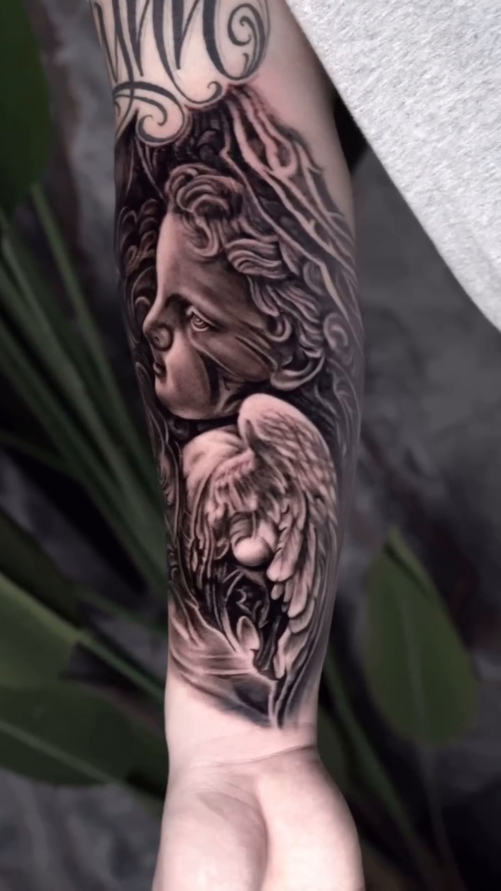 Angelic figures realism tattoo by Michael Sosa