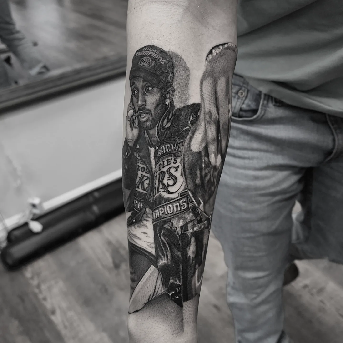 Tattooed figure black and grey tattoo on the forearm by Dani Ryan