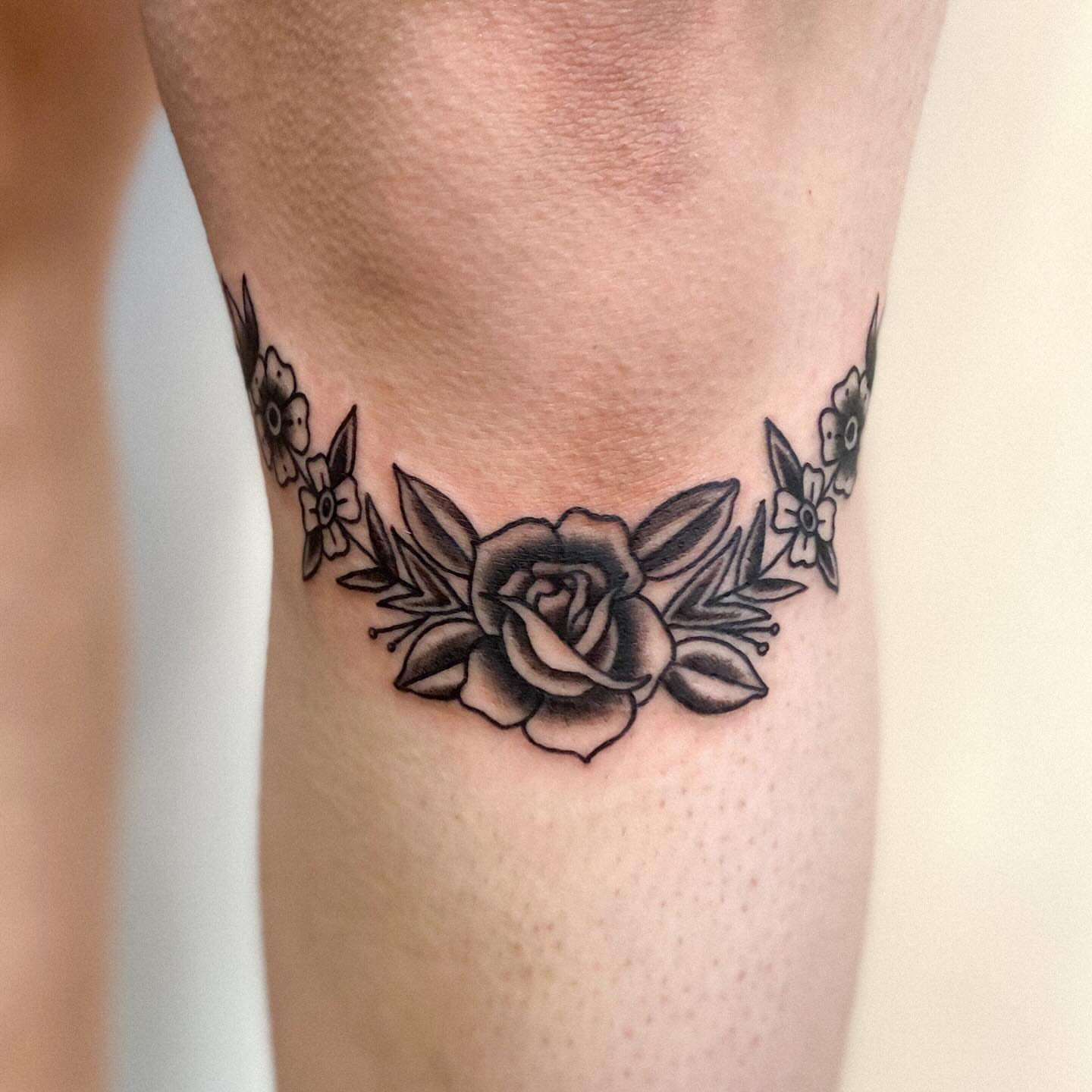 Floral wreath black and grey tattoo on the forearm by Katelyn Spence