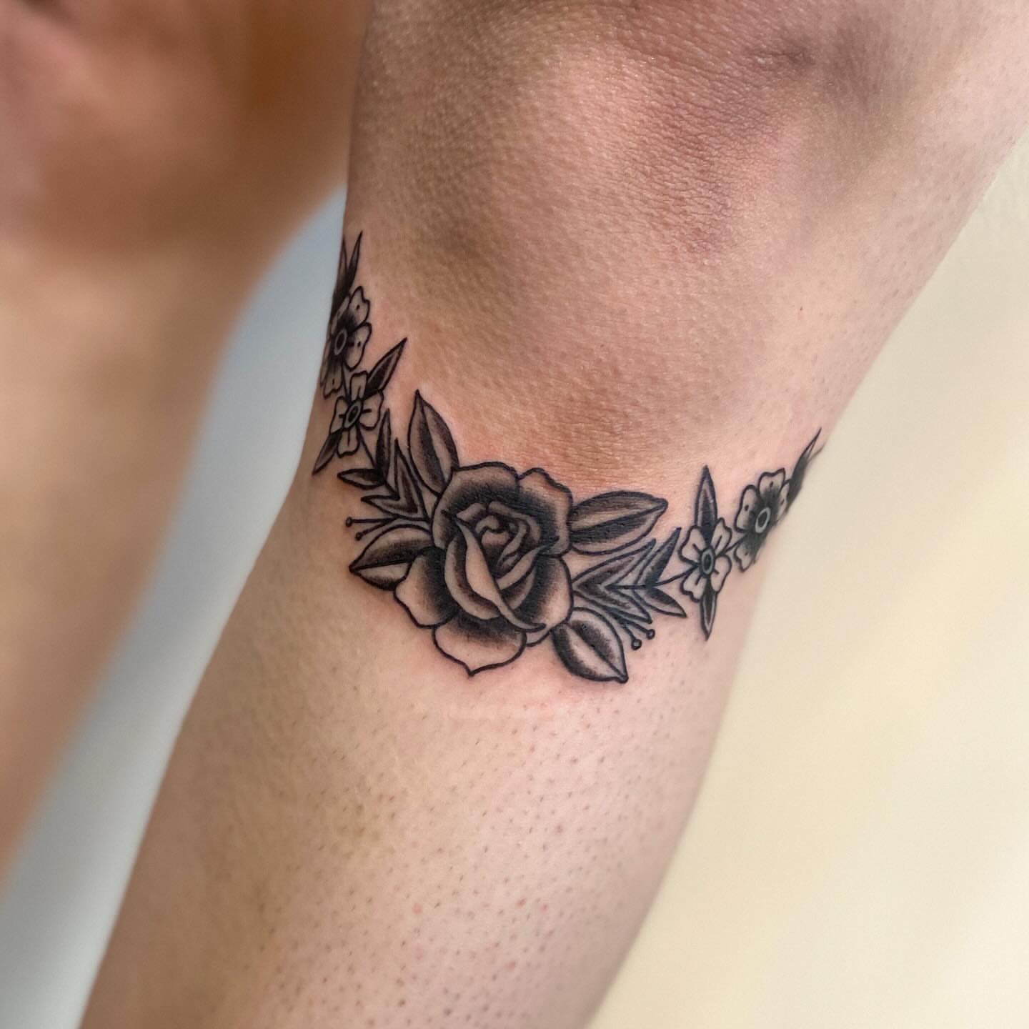 Floral arrangement black and grey tattoo on the forearm by Katelyn Spence