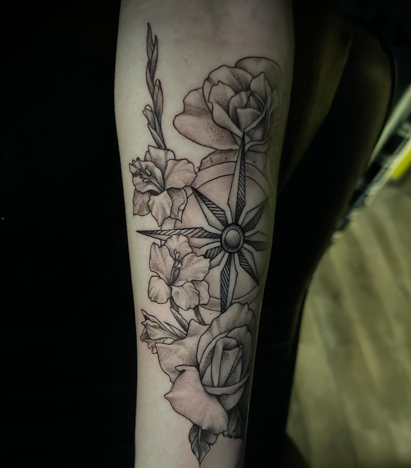 Roses and compass realism tattoo on the forearm by Dustin Lane Collins