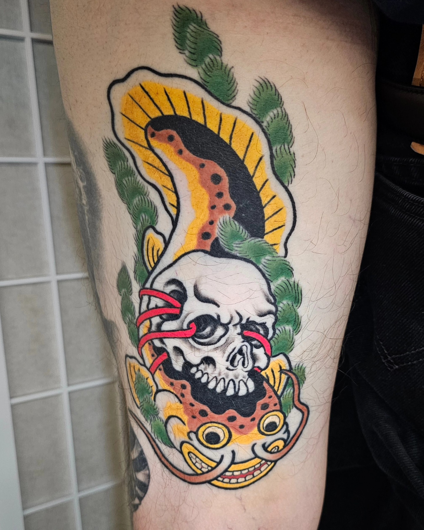 Skull with snake American traditional tattoo on the forearm by Avelourd Legaspi