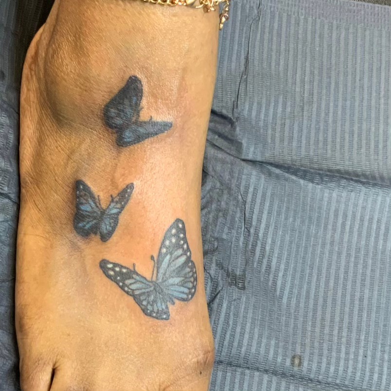 Butterflies fine line tattoo on the foot by Lopez Dautruche