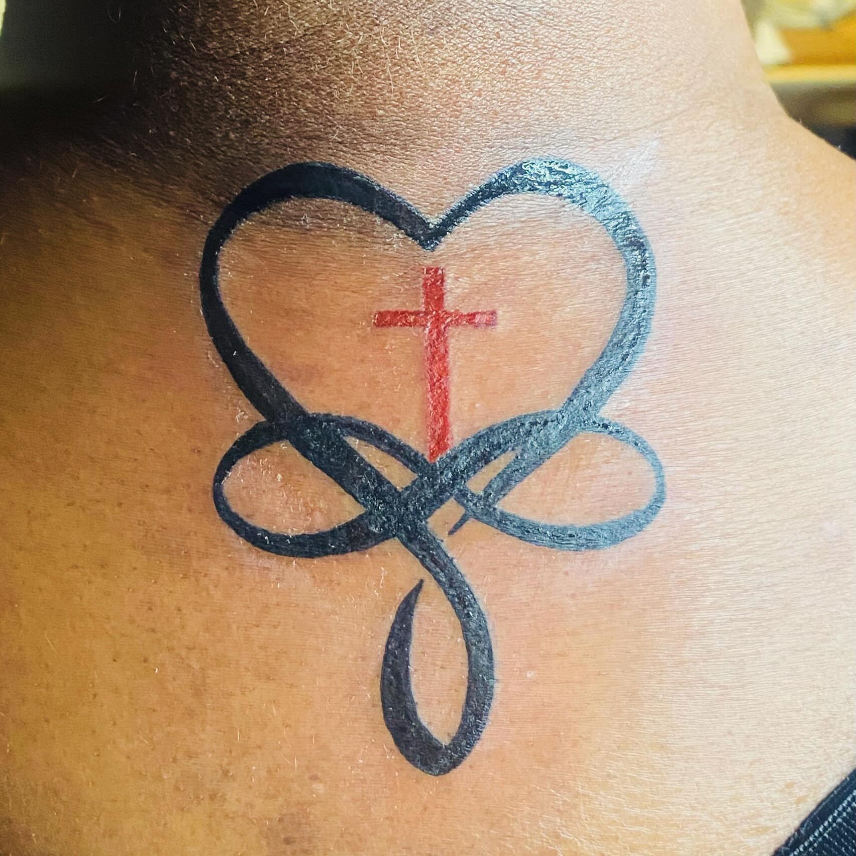 Heart with cross geometric tattoo on the neck by Tiffany