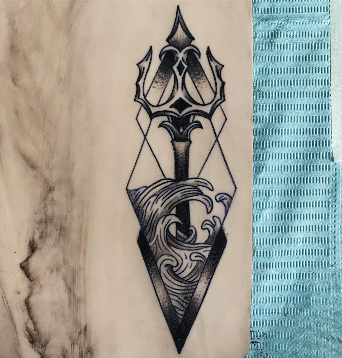 Trident and waves geometric tattoo by Tiffany