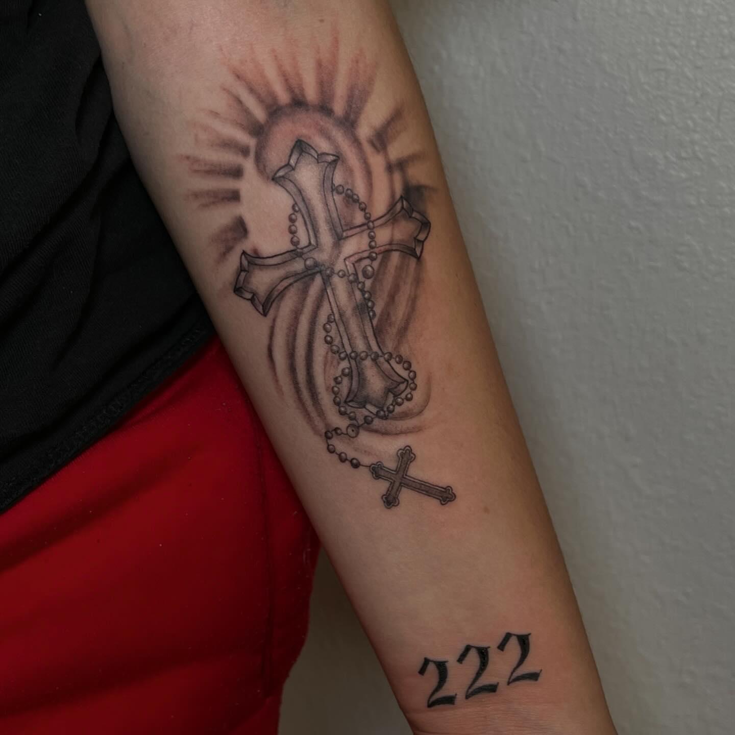 Cross and rosary black and grey tattoo on the forearm by josselyn ☪︎