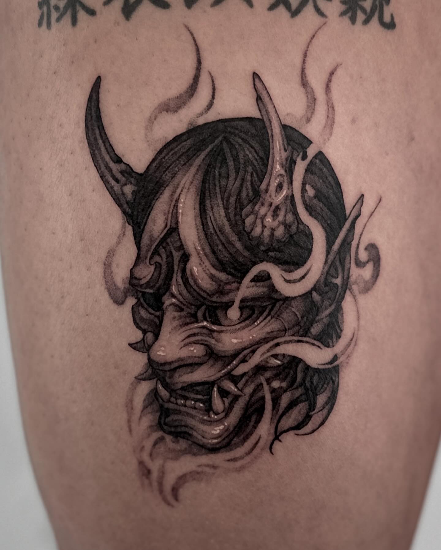 Demon mask realism tattoo on the thigh by 두식