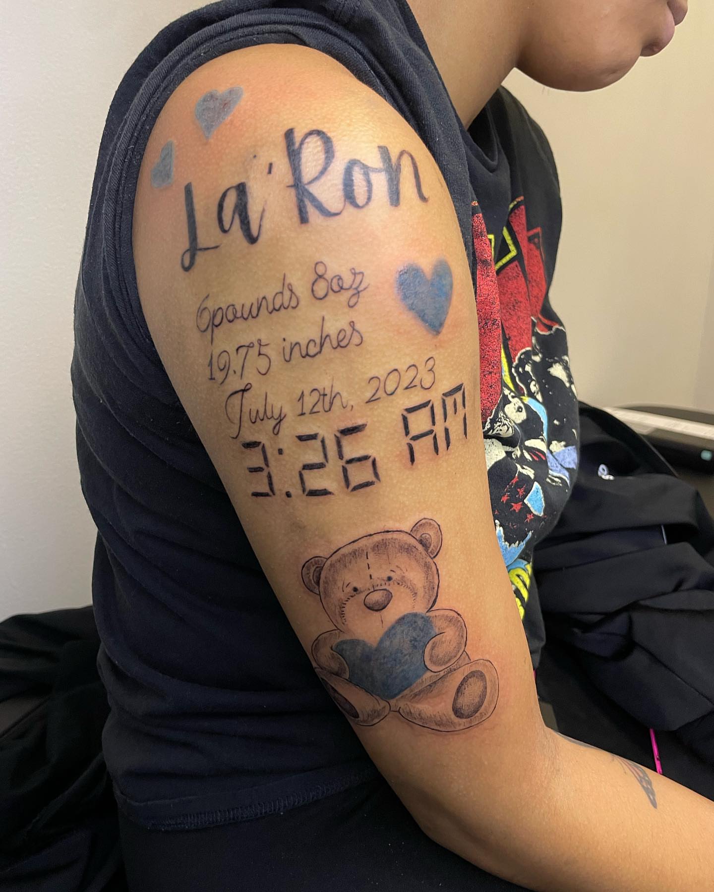 Baby birth announcement black and grey tattoo on the forearm by Dinero Inks