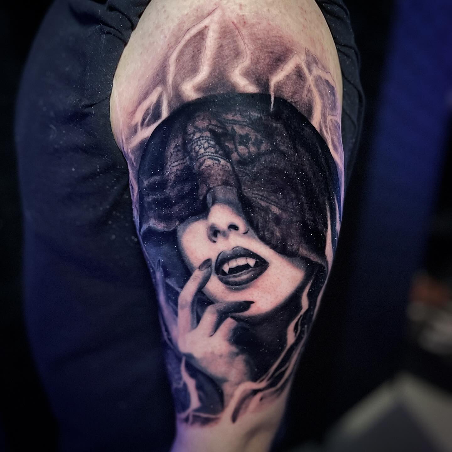 Woman with vampire teeth dark realism tattoo on the forearm by Joe Beasley