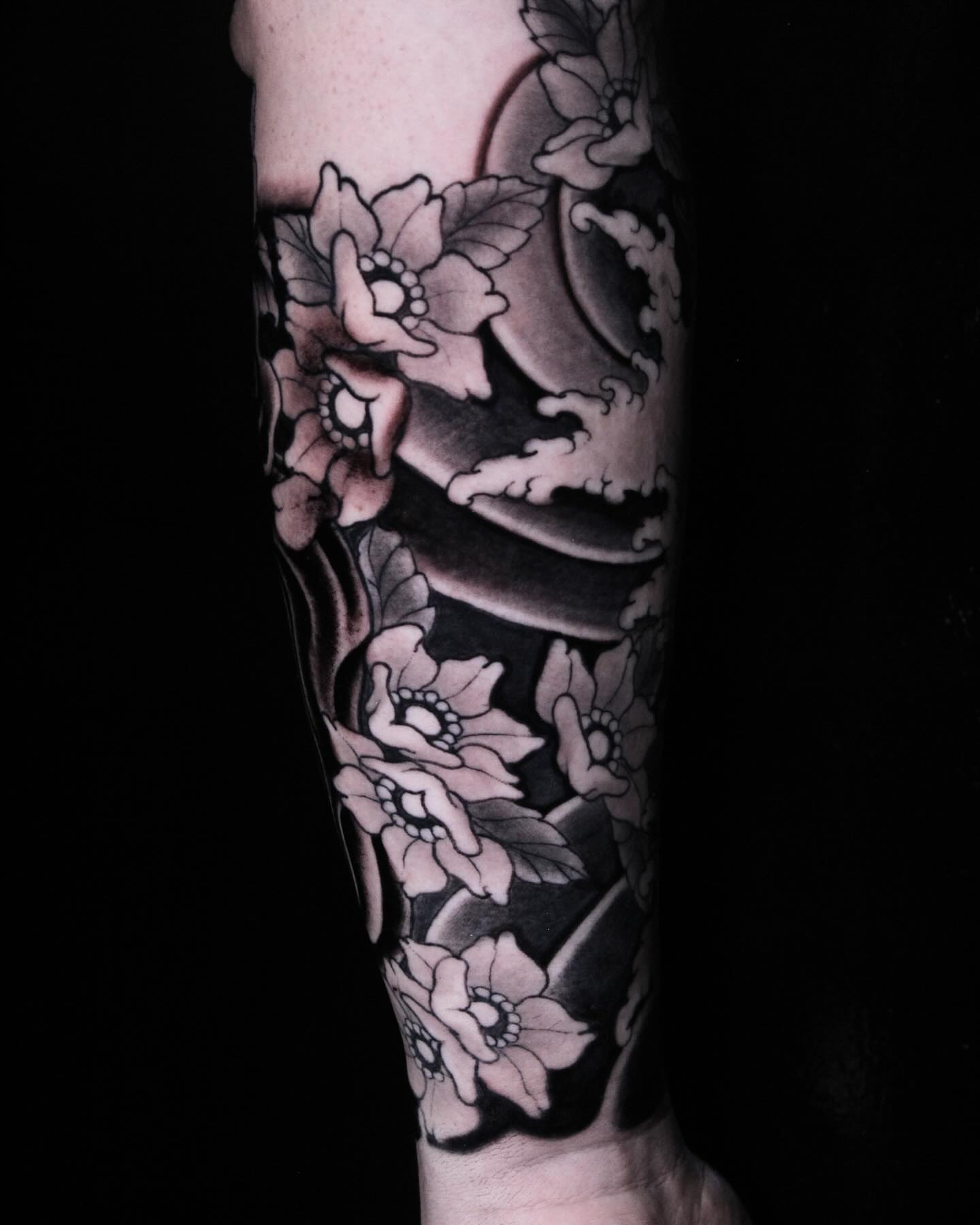 Floral arrangement black and grey tattoo on the forearm by Alezumie