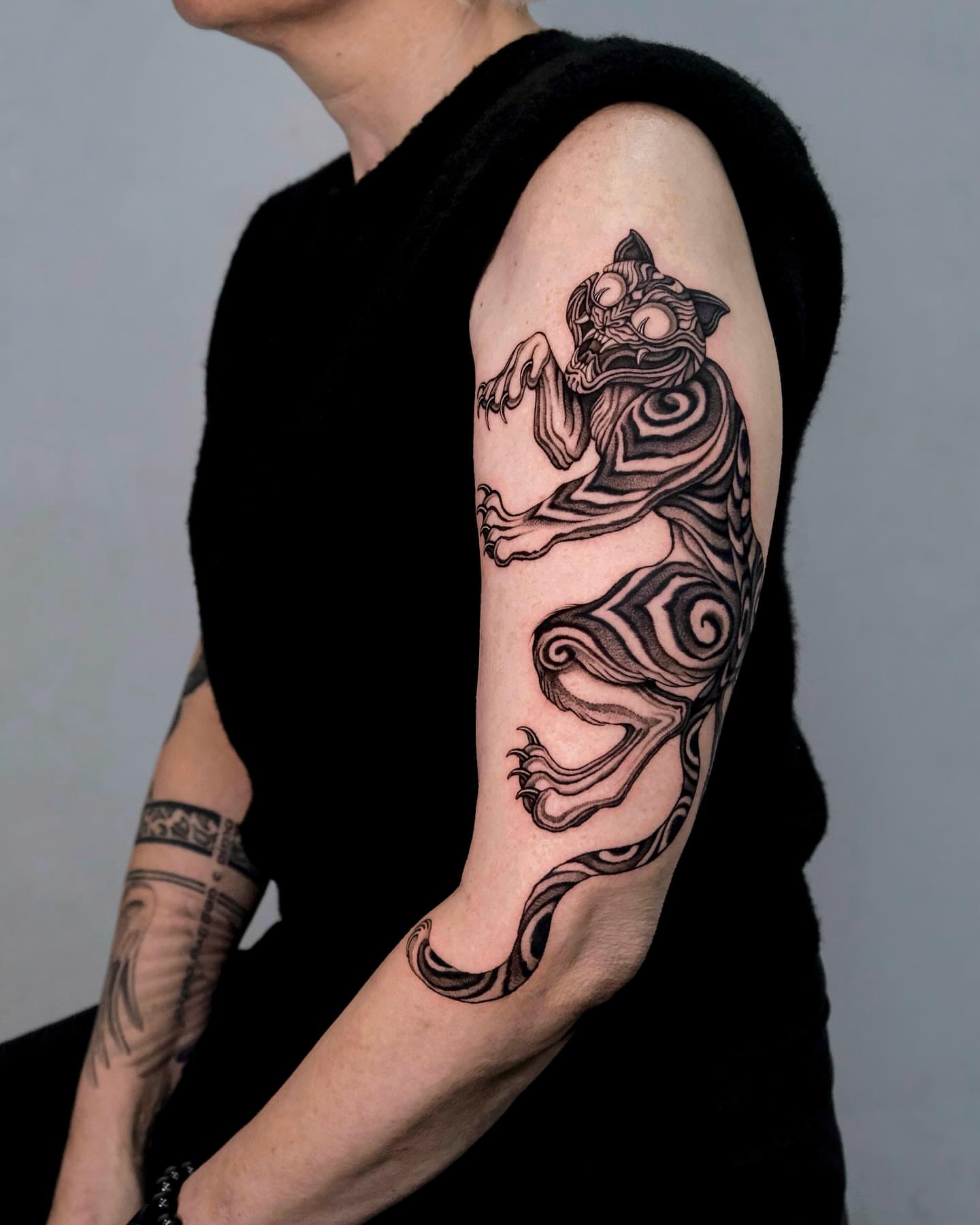 Cat black and grey tattoo on the forearm by Monkey Bob Tattoo