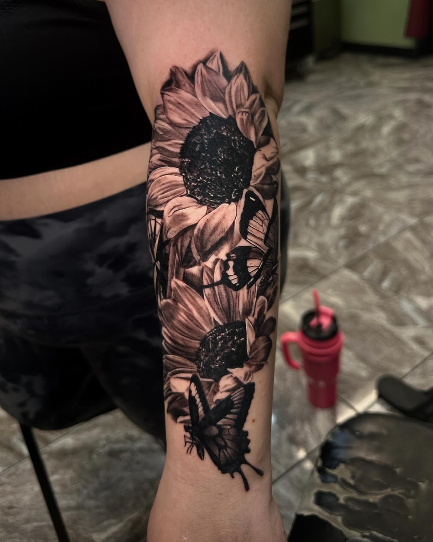 Sunflower and butterflies realism tattoo on the forearm by Billy Harris